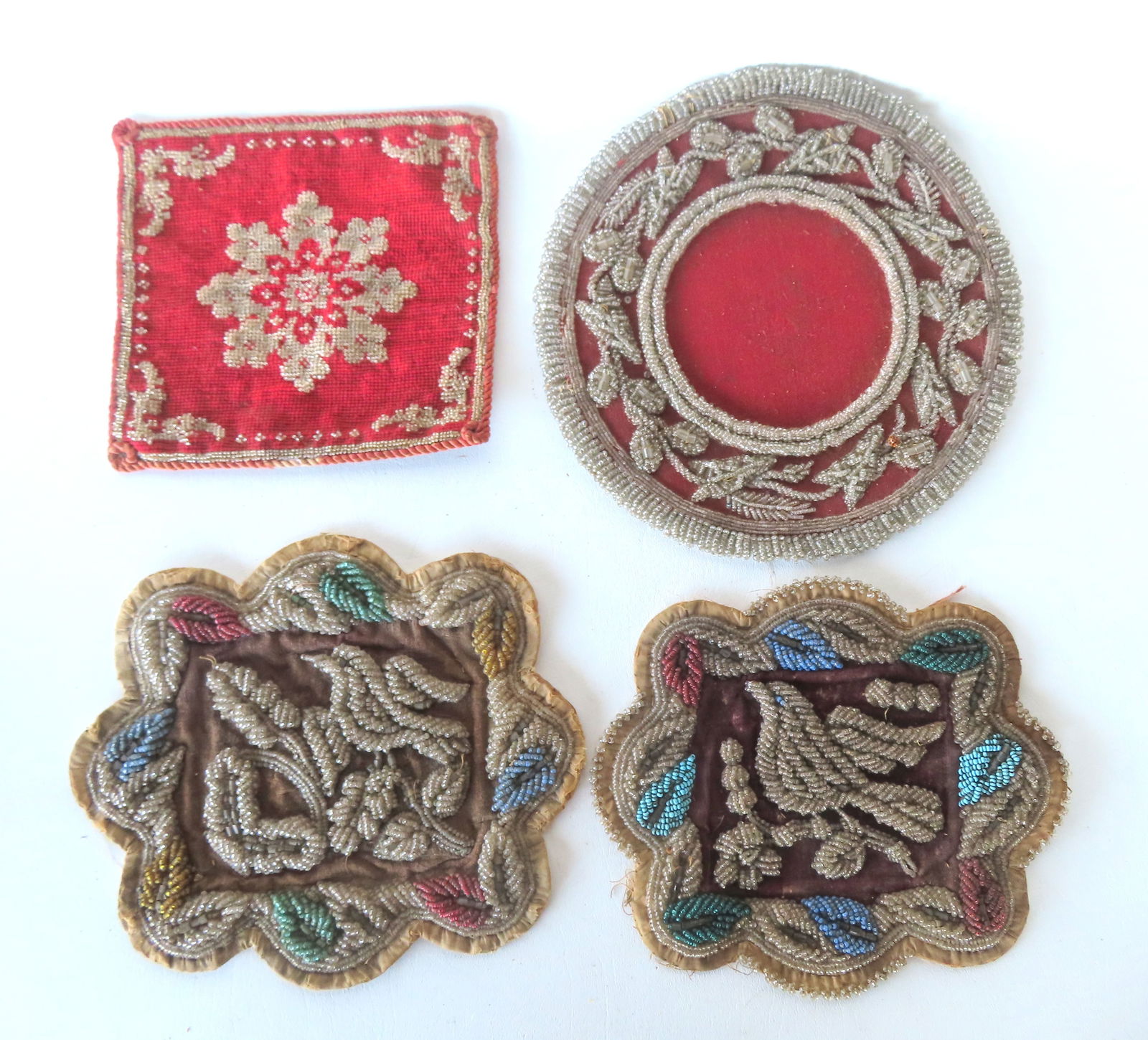 Grouping of 4 Iroquois beaded whimsy's, including: 2 mats the same size which were made to be sewn t: Grouping of 4 Iroquois beaded whimsy's, including: 2 mats the same size which were made to be sewn together for the making of a double sided pillow, each with shaped sides and decorated with bird on b