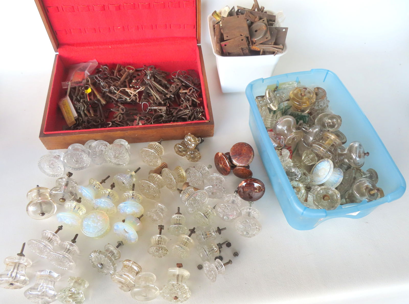 Large grouping of early hardware including keys, locks, and glass knobs (some Sandwich glass). Most: Large grouping of early hardware including vintage keys, locks, and glass knobs (many 19th century and probably sandwich glass). Several Bennington knobs with chips and some of the class knobs with ch