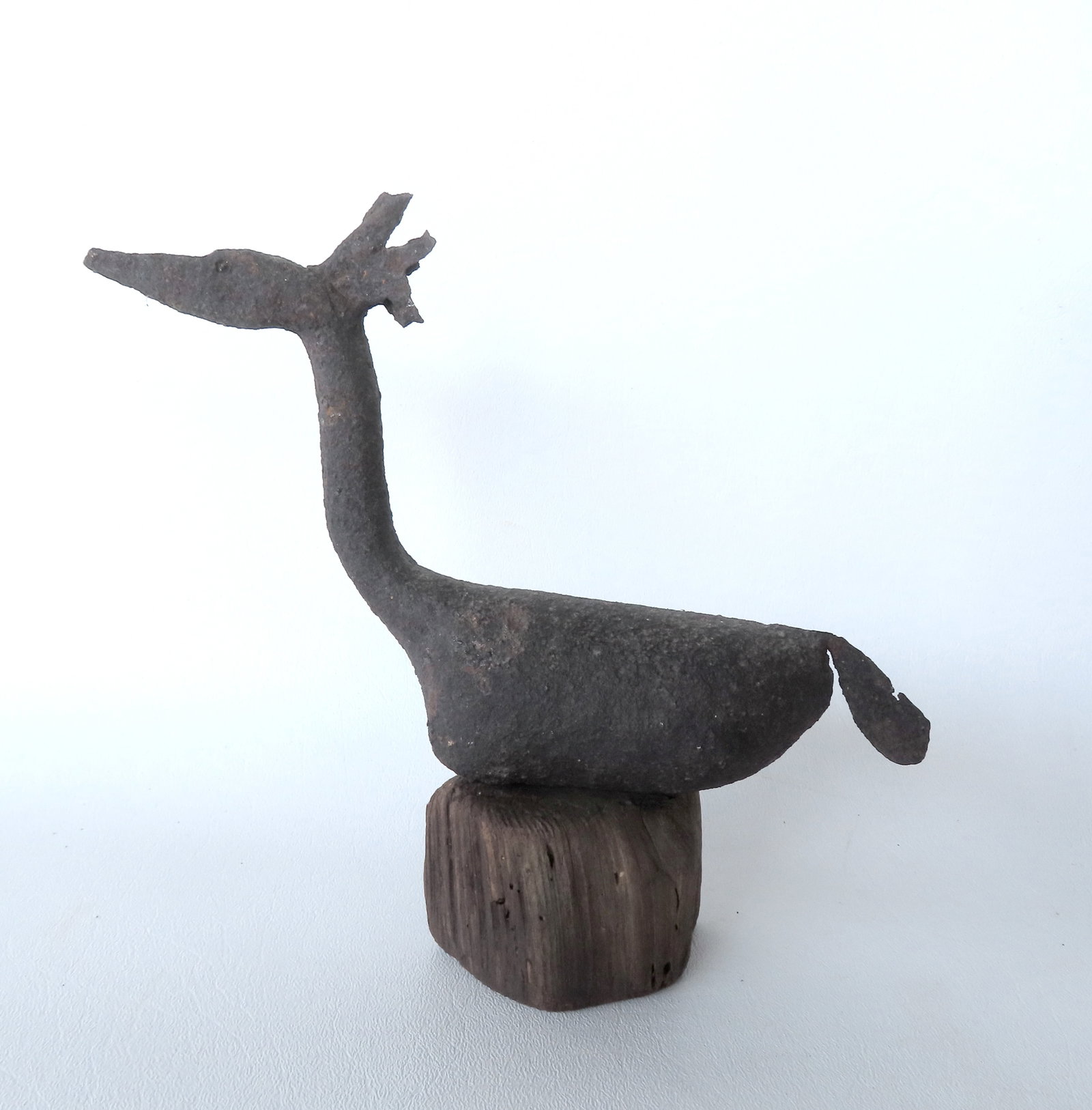 An early hand forged iron miniature stylized merganser decoy, probably 18th/19th century. Some minor: An early hand forged iron miniature stylized merganser decoy, probably 18th/19th century. Some minor pitting, small loss at end of tail, but overall good condition. Measures 9 1/2"L x 5 1/2"H.