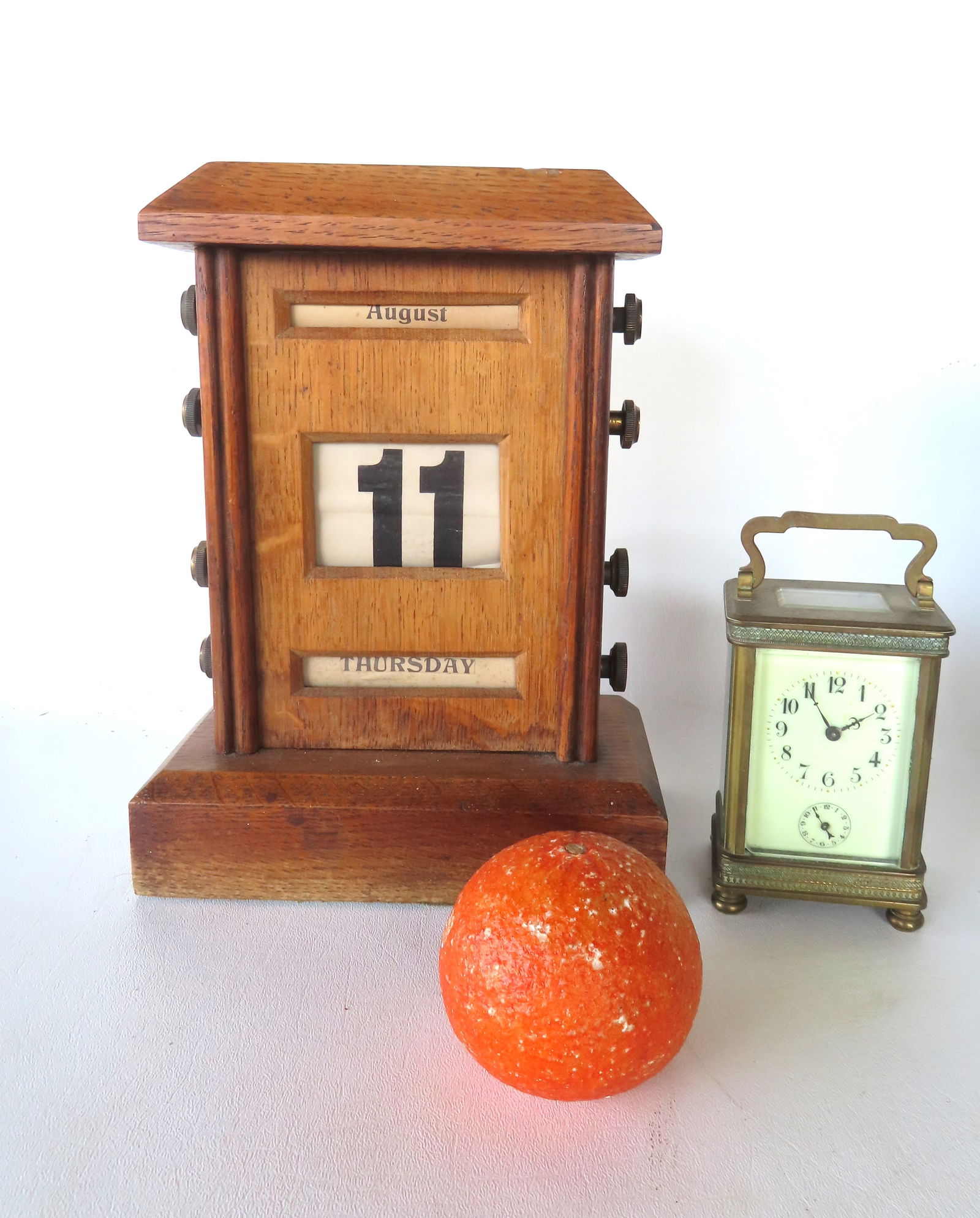 Two vintage decorative accessories that need work including: An oak desk top manual operated calenda: Two vintage decorative accessories that need work including: An oak desk top manual operated calendar indicating the day of the week, the date of the month, and the month itself - needs work as the cy