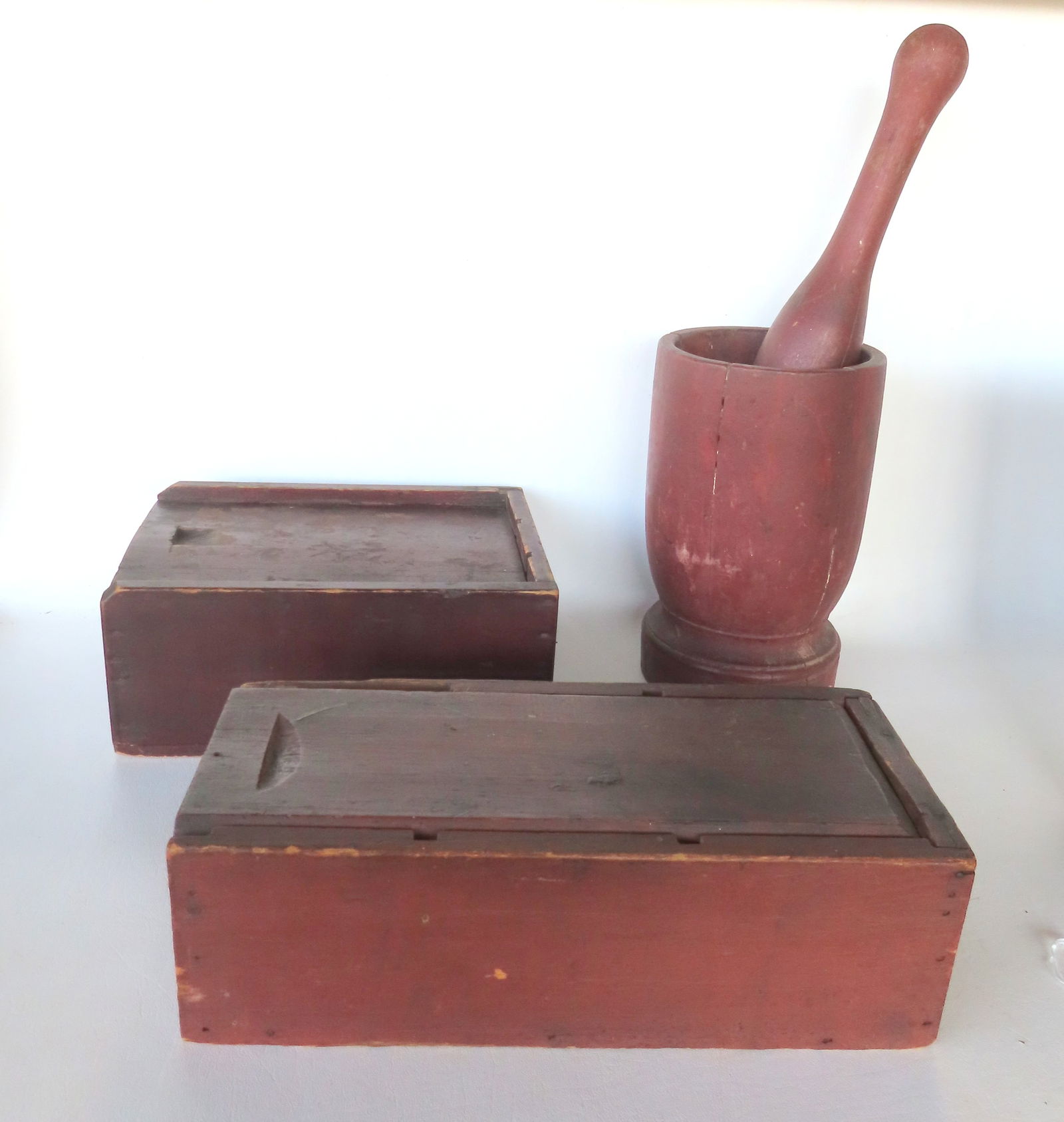 Three country items including a mortar & pestle in original red paint - some expansion cracks - mid: Three country items including a mortar & pestle in original red paint - some expansion cracks - mid 19th century -the pestle is the largest of the 2 measuring 13"H; a segmented slide lid box in origin