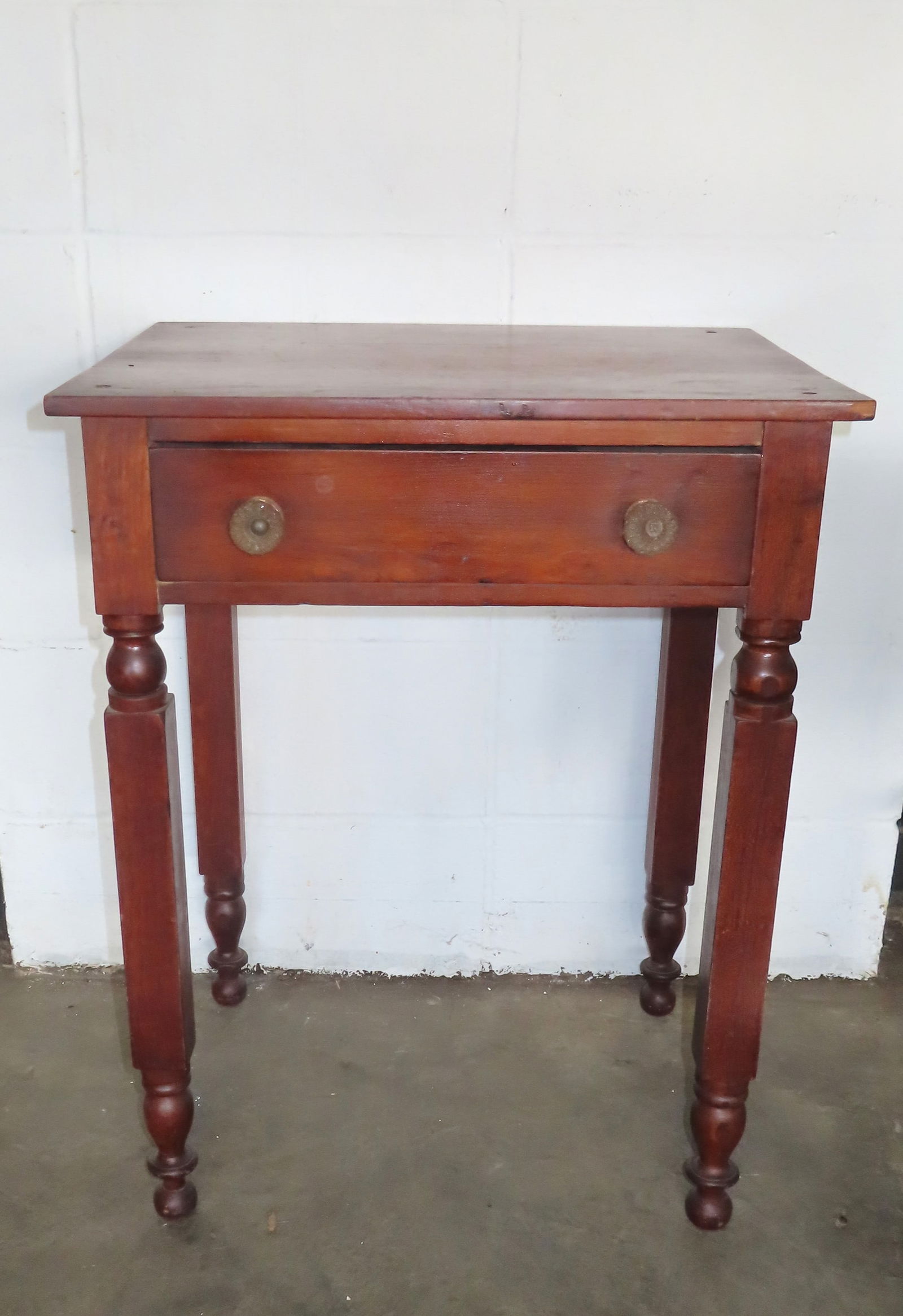 A one drawer work table with NY legs in cherry wood, circa 1850.: A one drawer work table with NY legs in cherry wood, circa 1850. The drawer with early glass pulls. The top has been reinforced with screws in each corner, else good condition.
