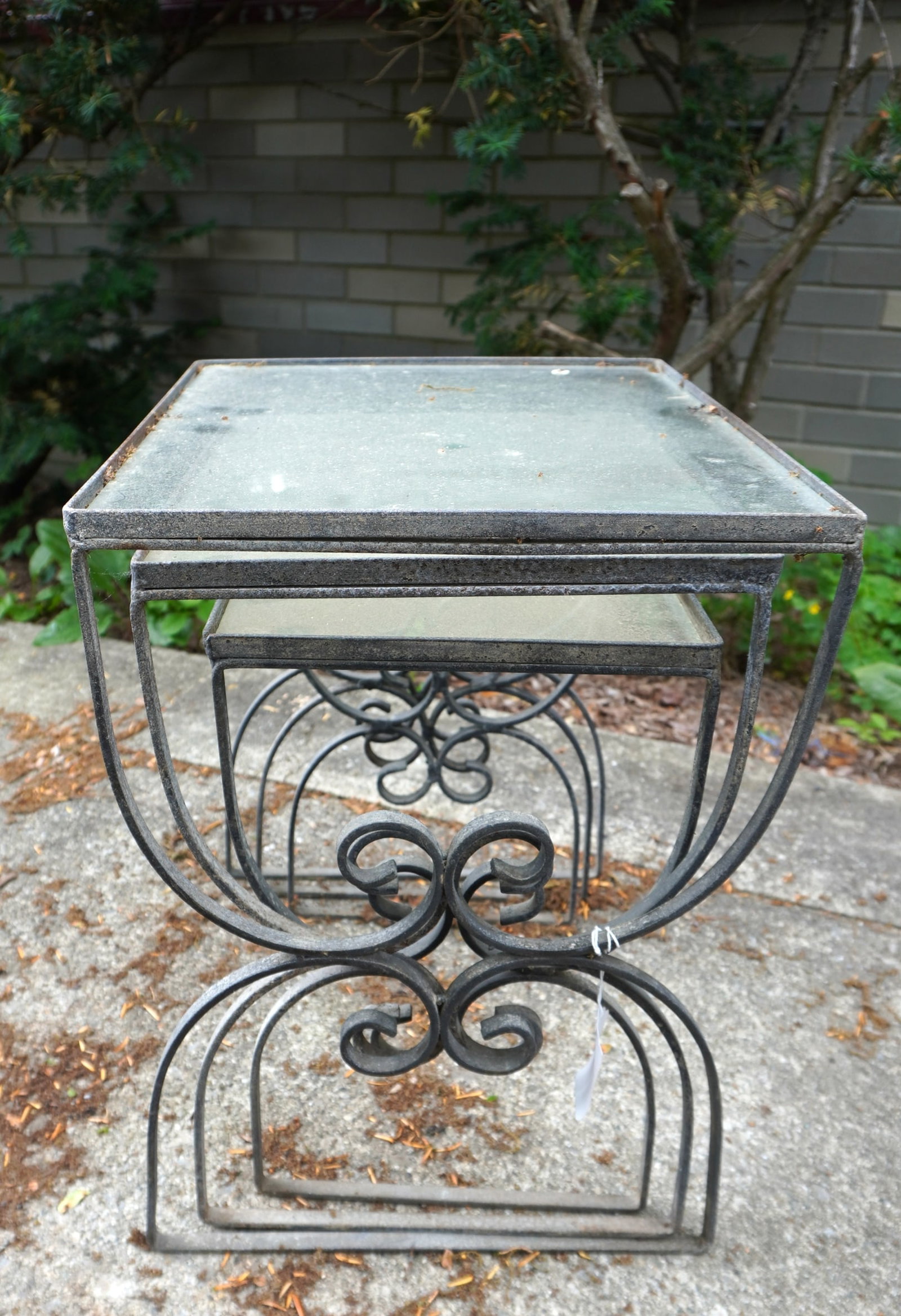 Grouping of 3 wrought iron stacking tables, circa 1960 - 2 of the glass tops with losses in corners, (1 of 3)