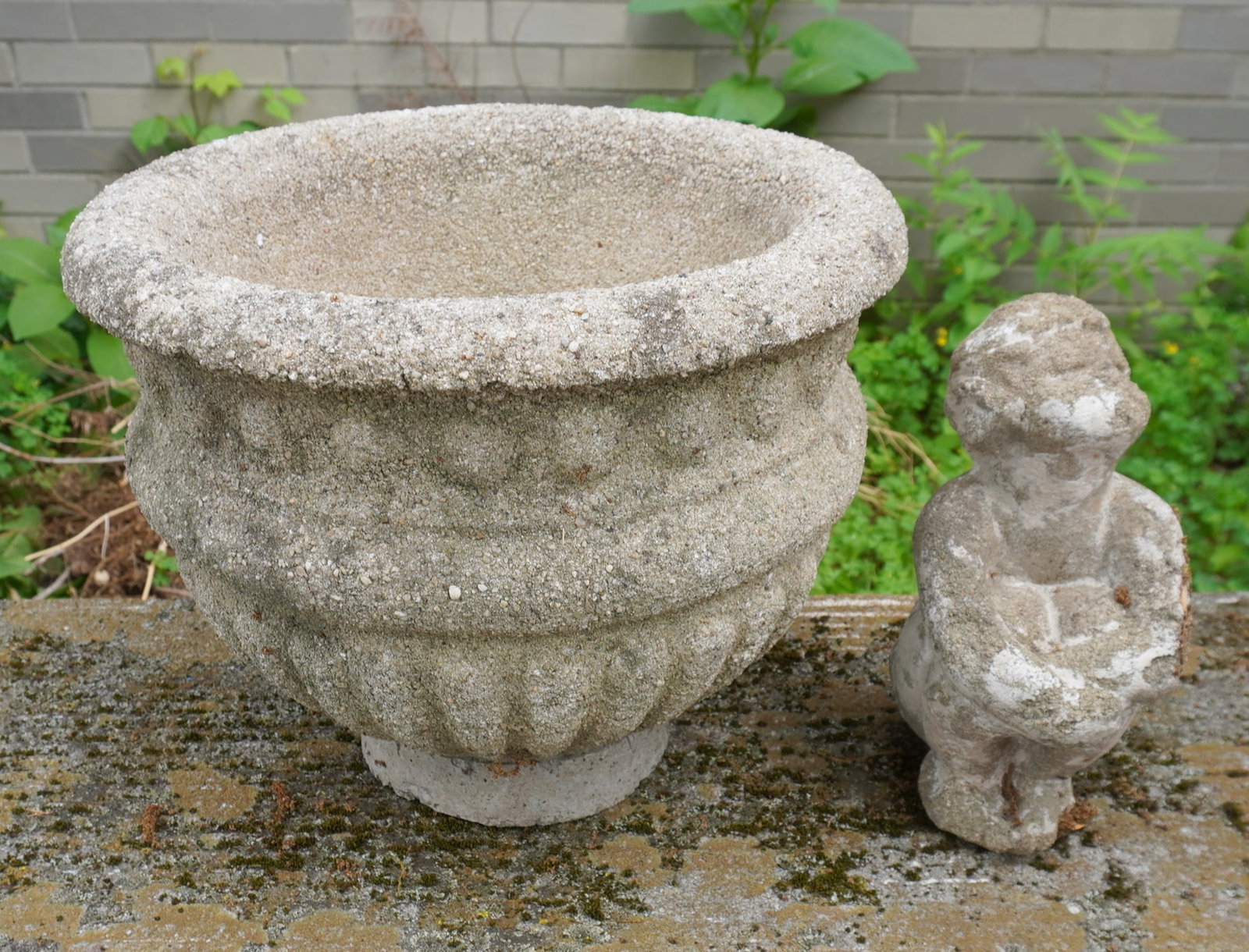 Concrete garden urn and a figural garden ornament. The urn with repair to base and the ornament with: Concrete garden urn and a figural garden ornament. The urn with repair to base and the ornament with loss at base, otherwise good condition, circa 1960. Provenance: From a local Clinton Corners NY est