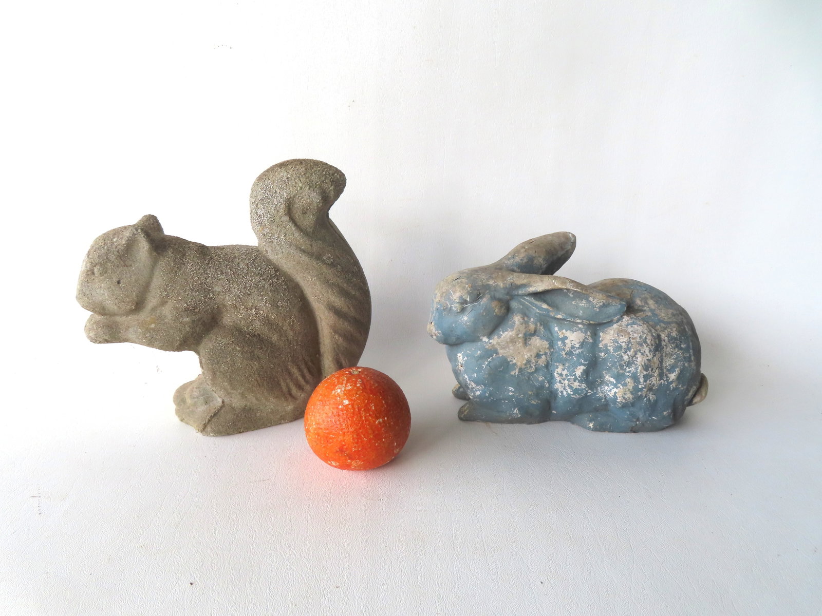 Two figural garden ornaments including a concrete squirrel and a composition rabbit in old paint. (1 of 6)
