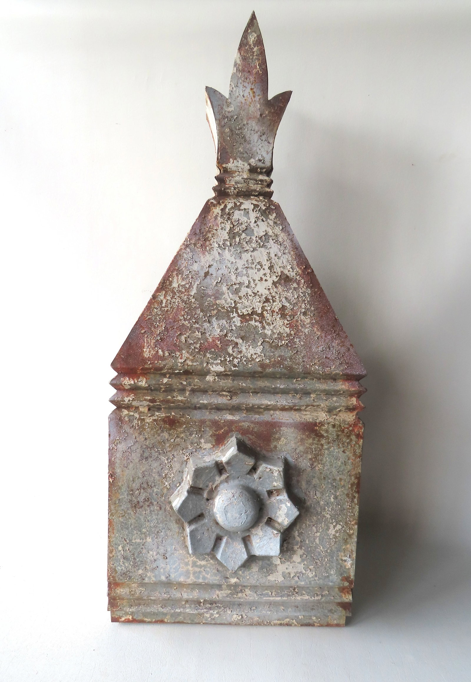 A 19th century tin architectural building finial with a large embossed flower on the front panel. (1 of 6)