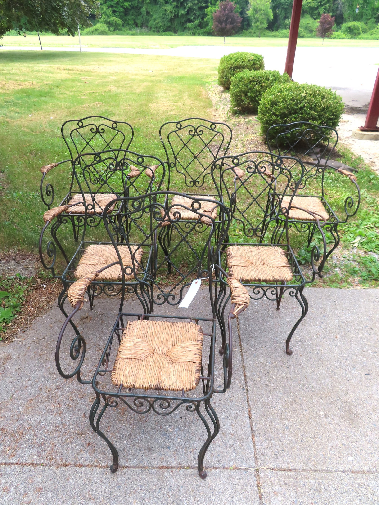 A matched set of 6 wrought iron French patio or porch chairs in original green paint, having a (1 of 8)
