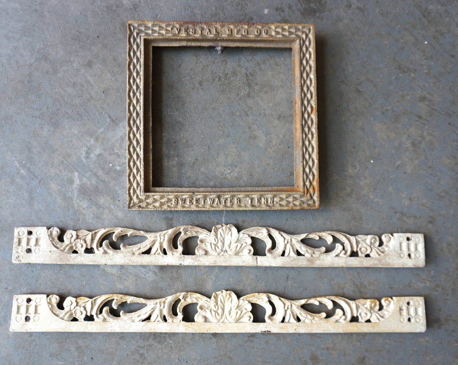 Three pieces of decorative cast iron including: A pair of narrow cornices decorated with open work (1 of 4)
