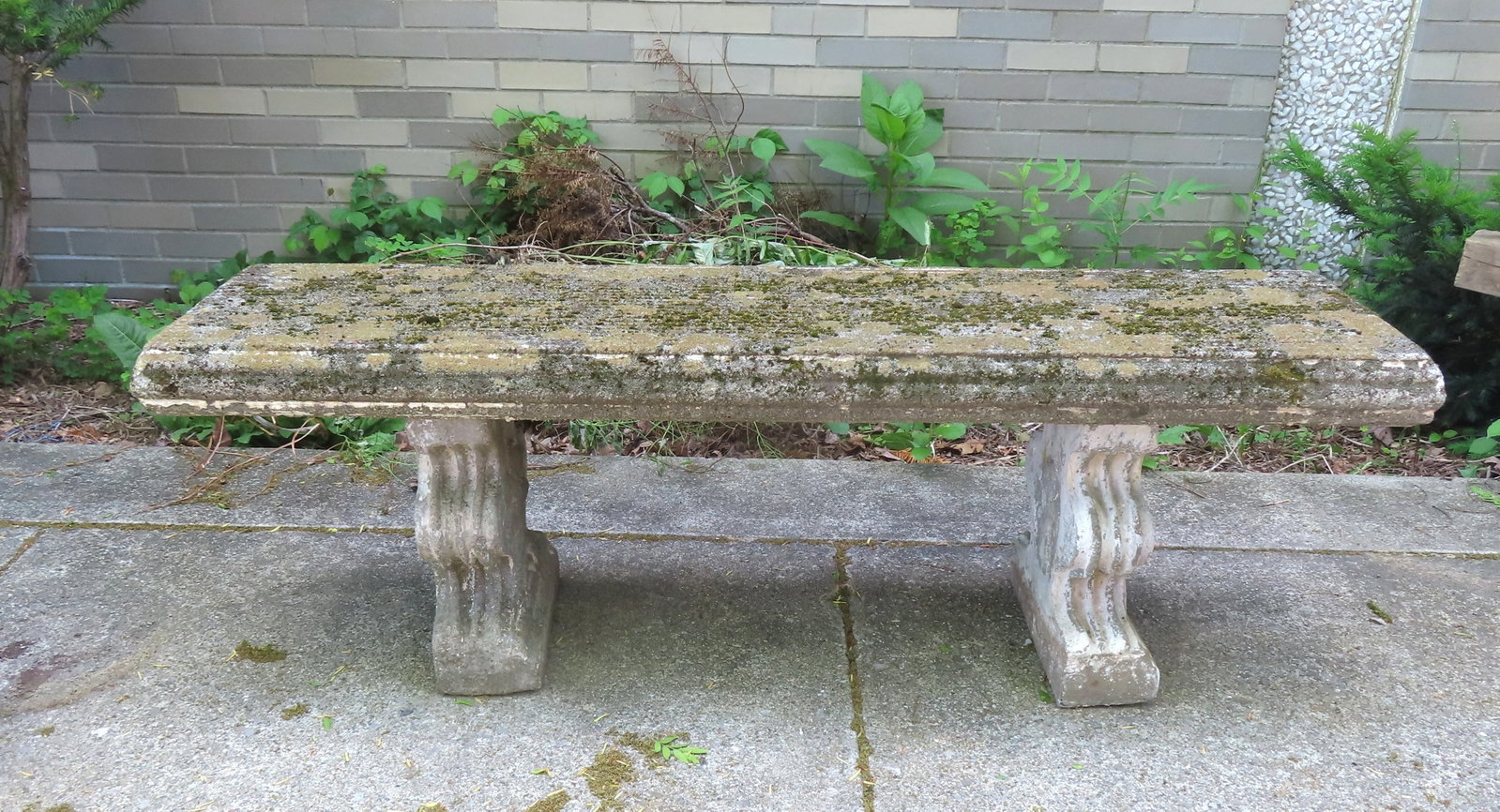 A good concrete bench covered with lichen, incised decorations on outside face of top supports. It (1 of 7)