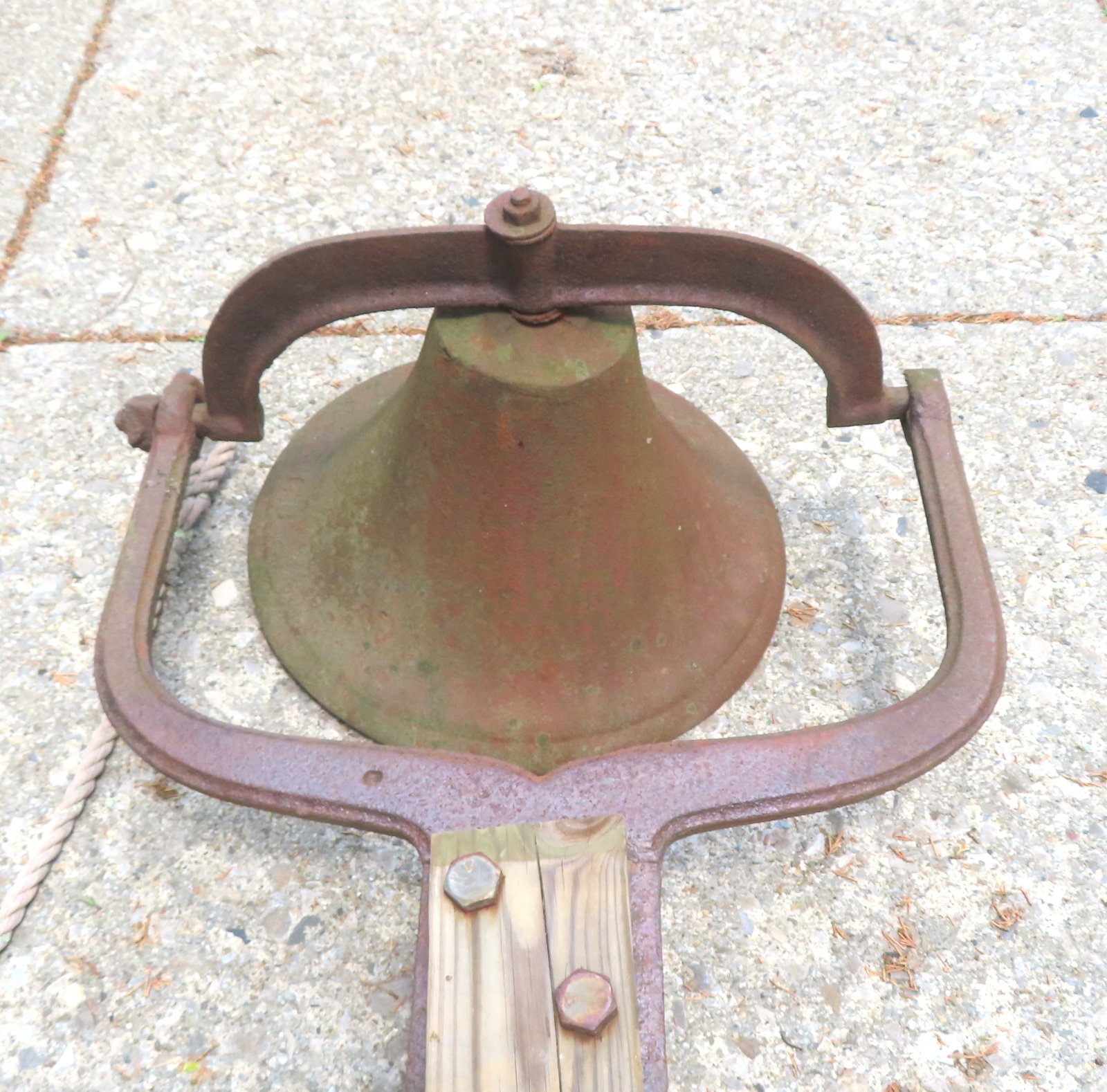 A vintage cast iron farm bell mounted on newer treated lumber post, probably late 19th century. The (1 of 12)