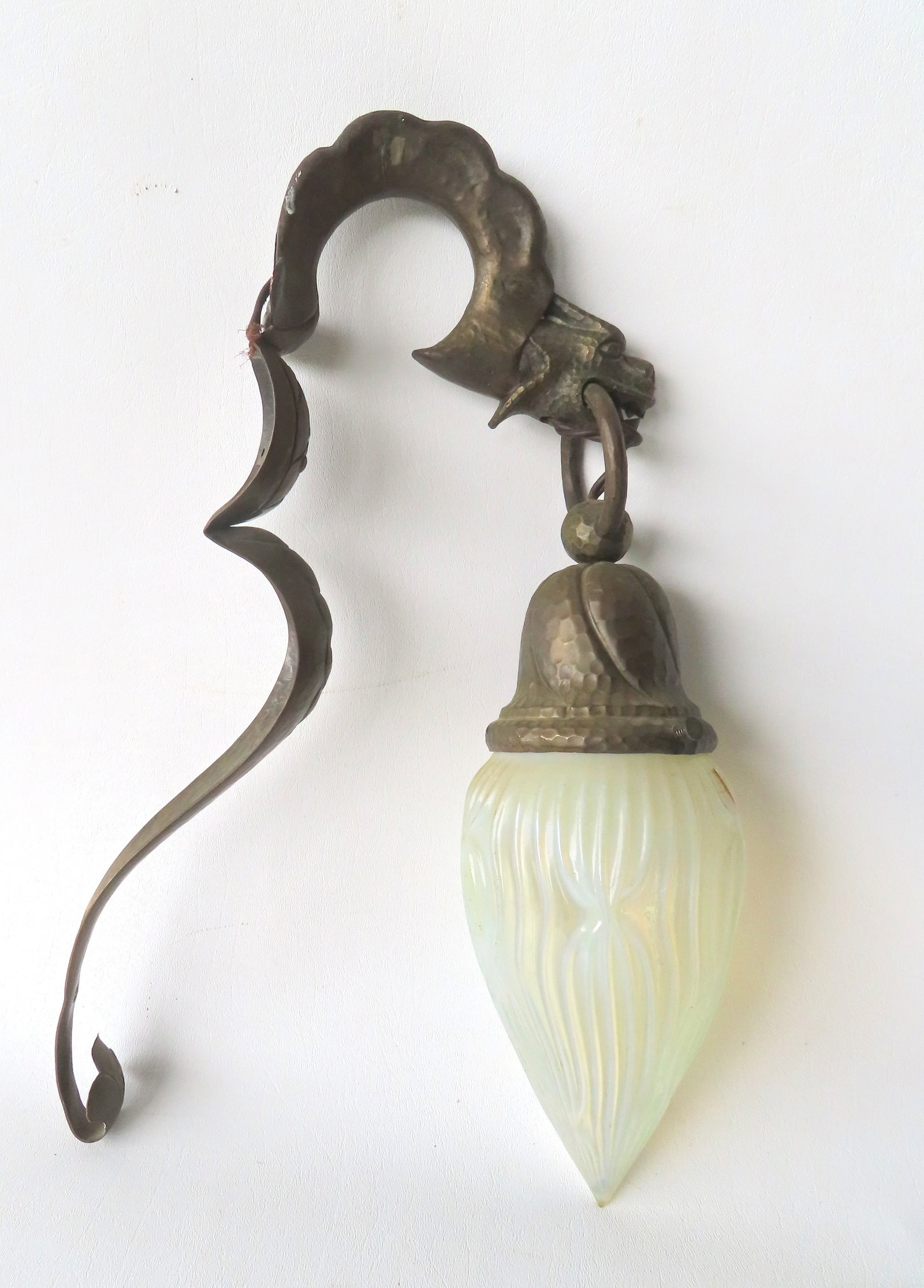 An unusual Arts & Crafts wall light in the form of a hand hammered copper dragon with a white: An unusual Arts & Crafts wall light in the form of a hand hammered copper dragon with a white opalescent shade which is likely original, circa 1920-30. Both the fixture and the shade are in very good 