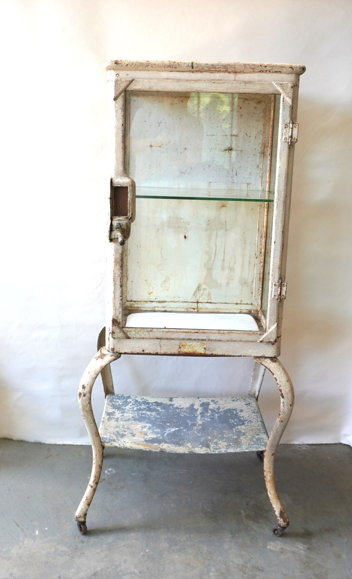 A heavy iron medicinal cabinet mounted on a matching iron base with cabriole shaped legs, late 19th (1 of 8)