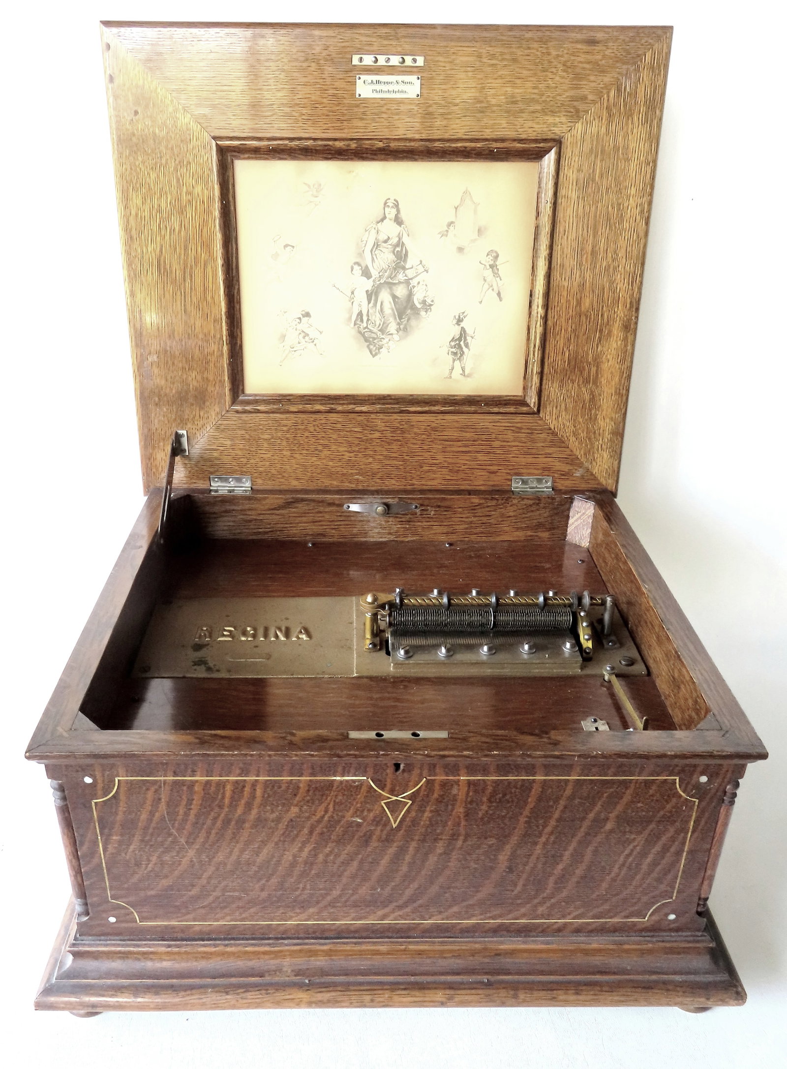 An oak Regina double comb disc music box, serial number 52447. Label attached to underside of lid (1 of 14)
