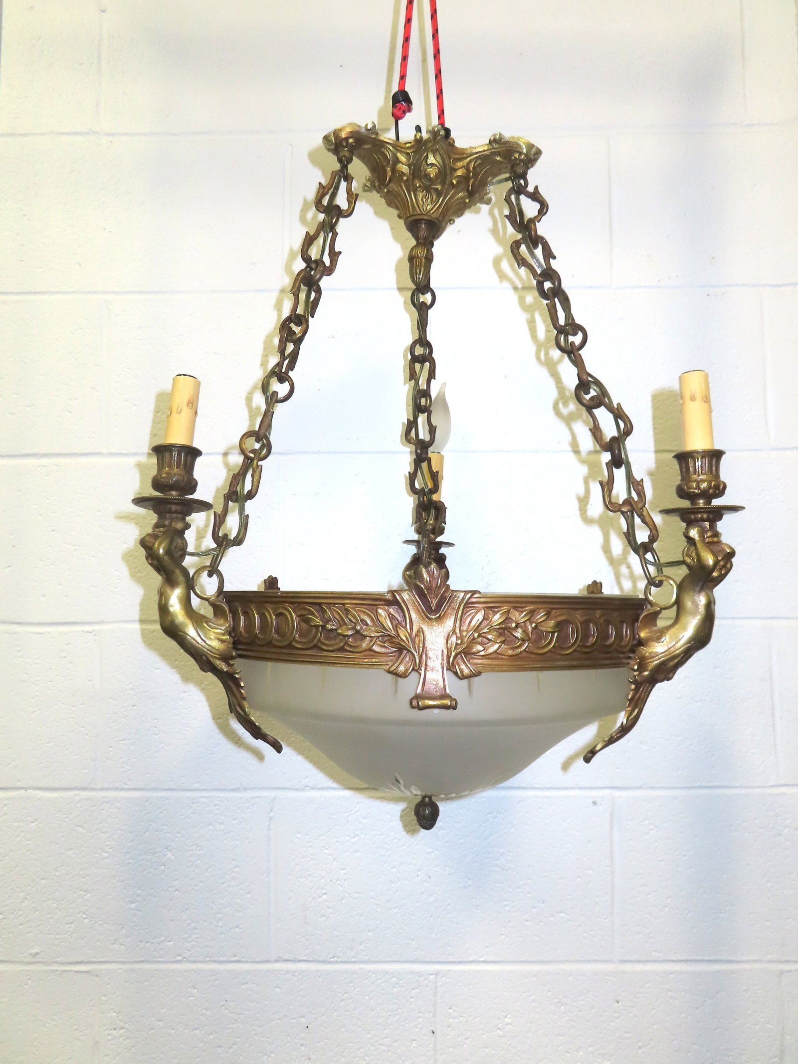 A classical architectural style French chandelier having a circular apron with embossed decorations (1 of 18)