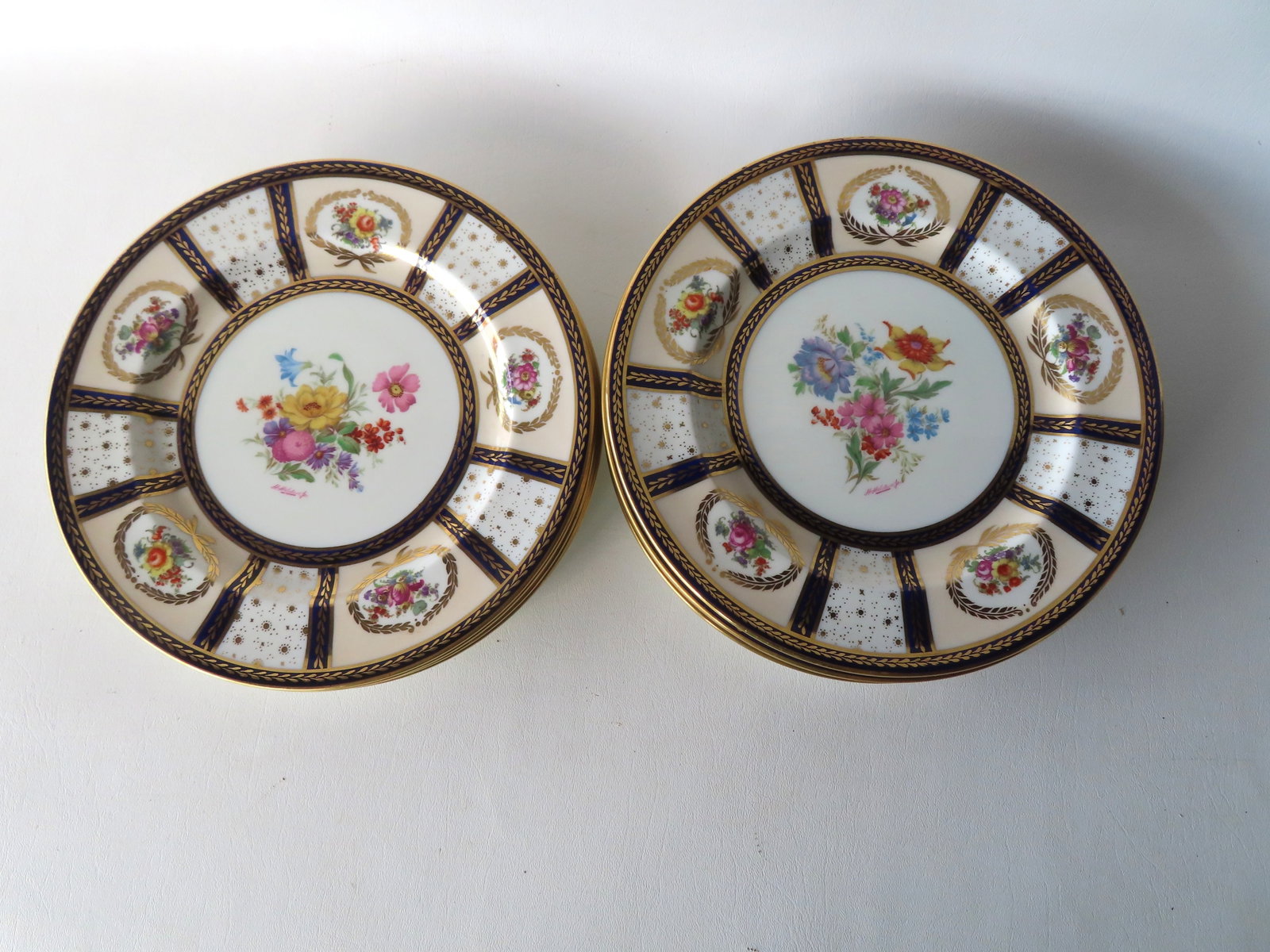 A matched set of 10 hand painted floral service plates, artist signed, and marked "Paragon China /: A matched set of 10 hand painted floral service plates, artist signed, and marked "Paragon China / Made in England / Reproduction of Service Made For Her Majesty Queen Mary April 22 1913" - the centra