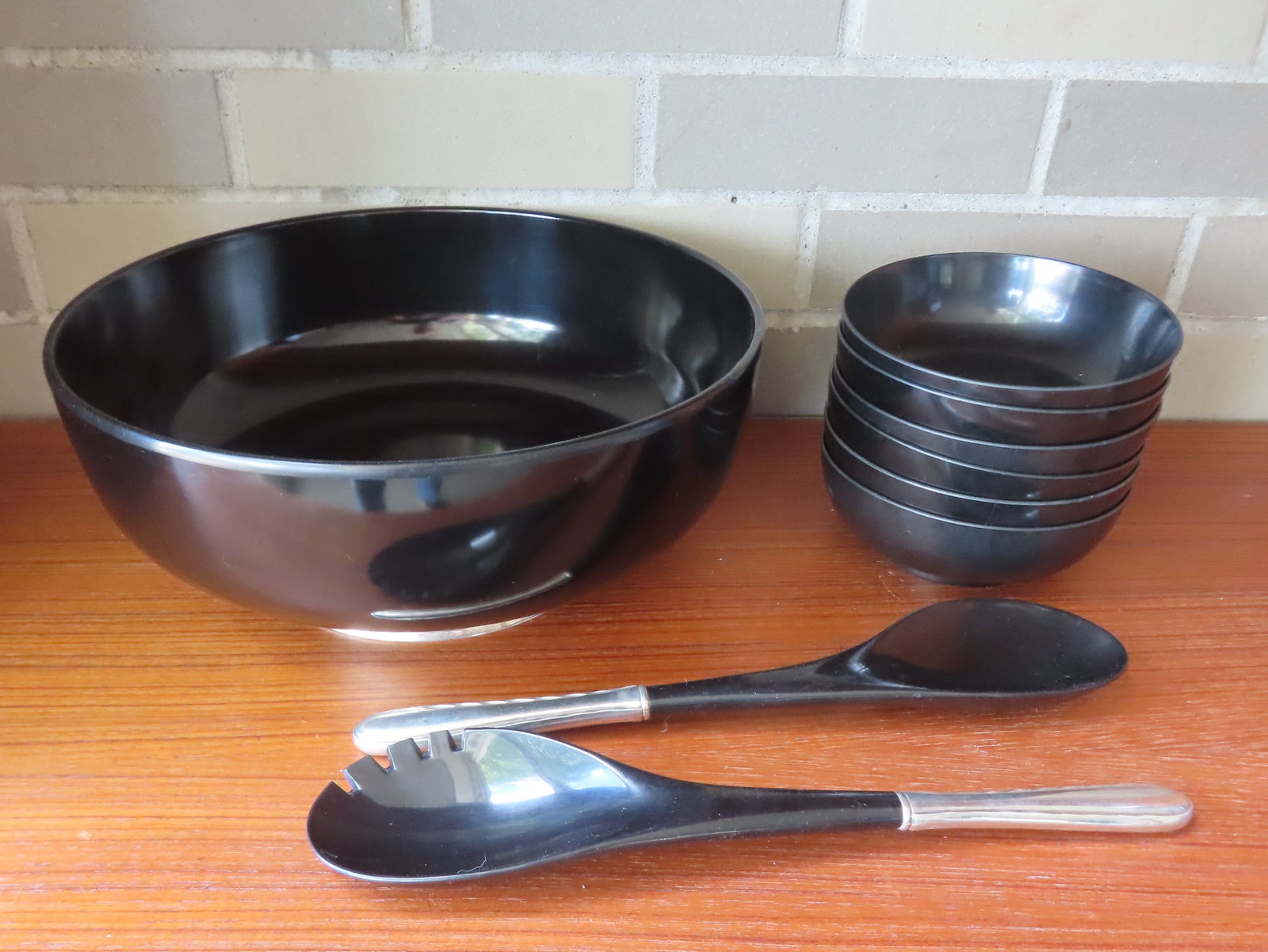 A signed "Towle Sterling 325" nine piece matching salad set. It features a large black melamine: A signed "Towle Sterling 325" nine piece matching salad set. It features a large black melamine plastic salad bowl - 11 1/2" diameter x 4"H with a sterling silver footed base, 2 matching black malamin