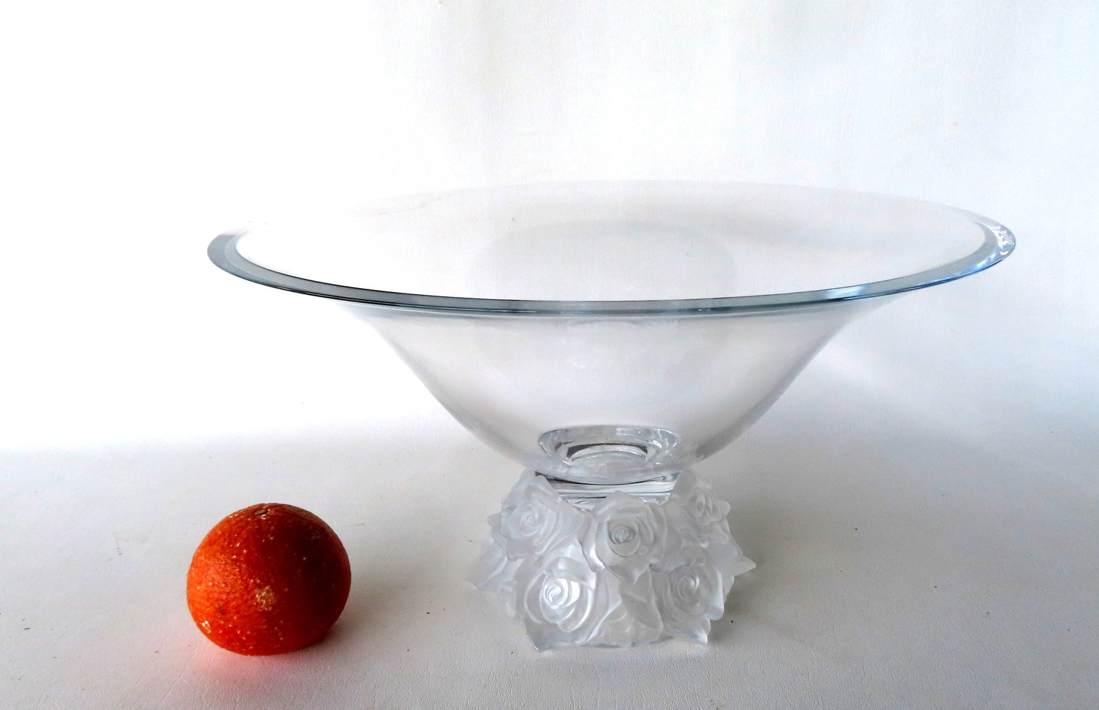 A large colorless glass bowl with embossed floral base, and cut and polished rim, similar to (1 of 4)