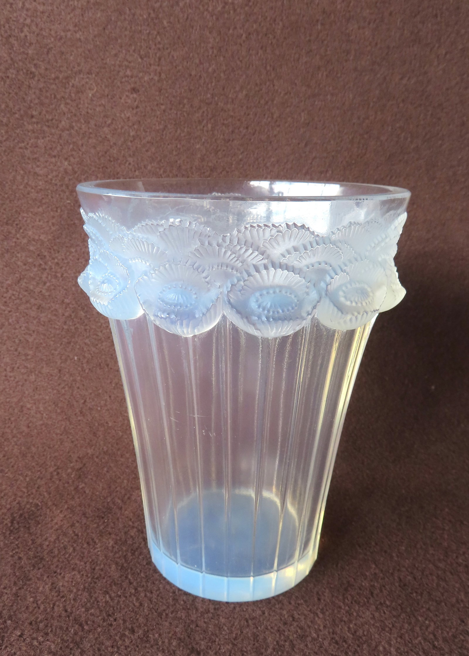 A Lalique "Boutons D'or" pattern vase decorated with overlapping opalescent frosted relief flowers: A Lalique "Boutons D'or" pattern vase decorated with overlapping opalescent frosted relief flowers under rim and having long stems that extend to opalescent base - signed "LALIQUE France", circa 1933.