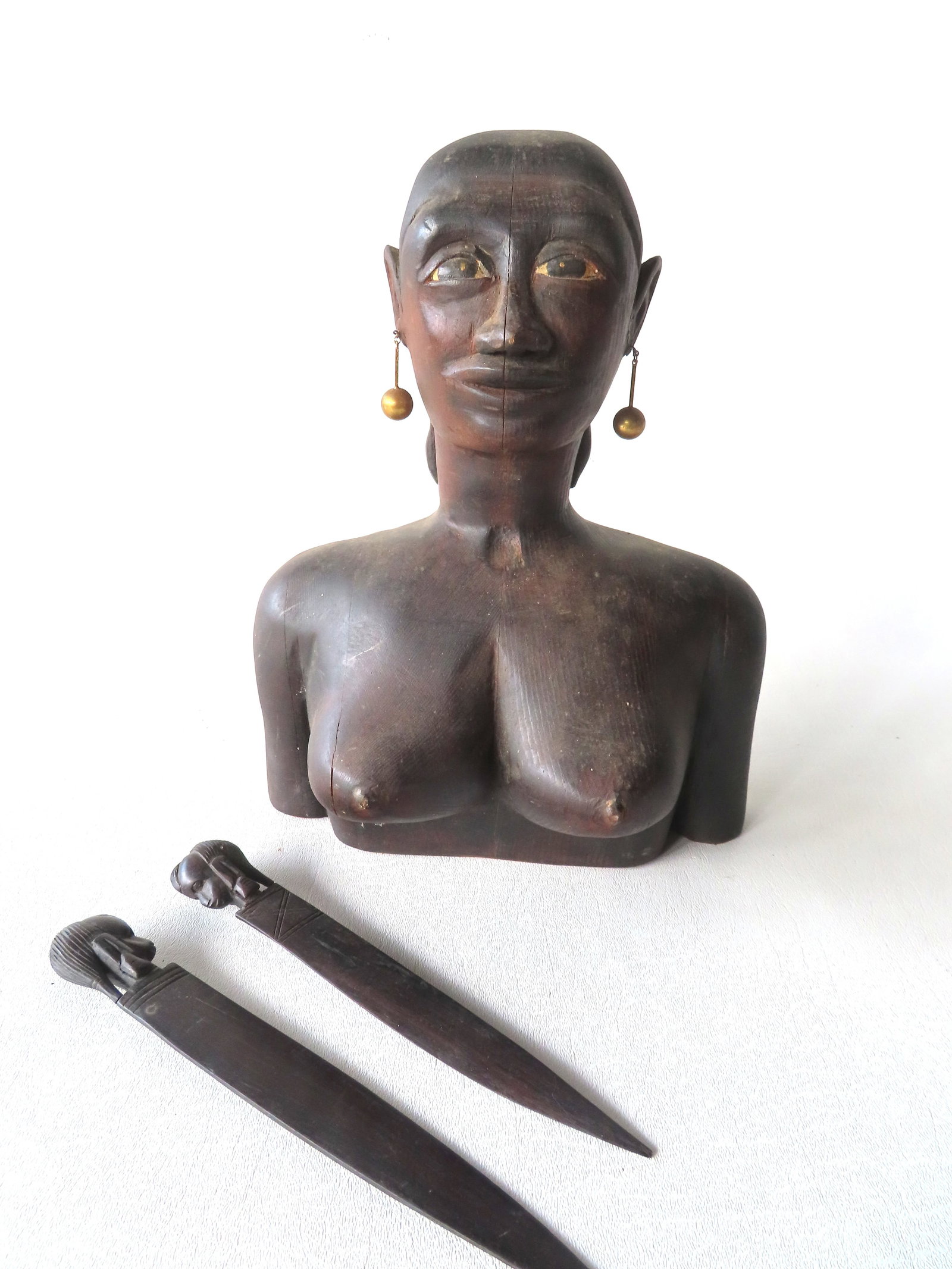 A carved folk art wooden bust of an African American woman, possibly a slave woman, wearing gold (1 of 10)