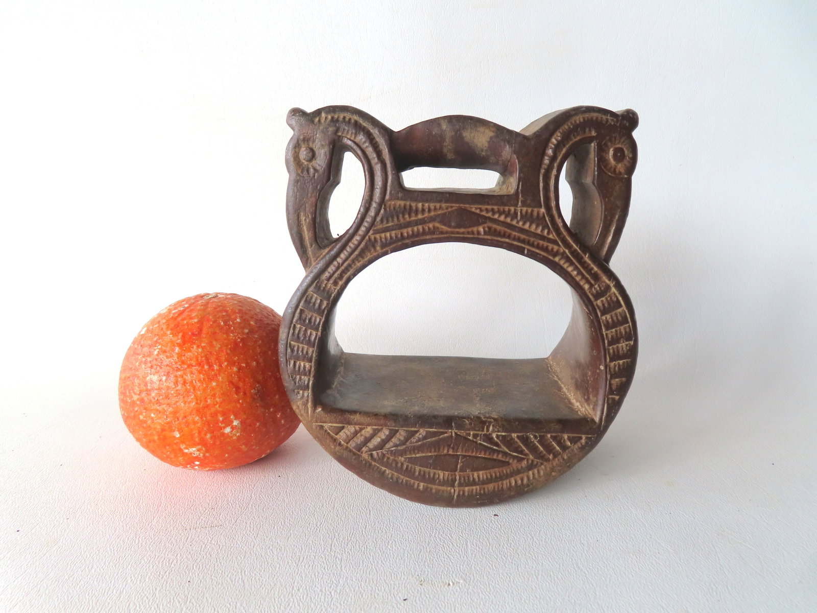 A rare carved wooden stirrup, decorated with stylized figures of an eagle, and being incised around: A rare carved wooden stirrup, decorated with stylized figures of an eagle, and being incised around the edges, probably Spanish early 19th century - it appears to be durable mahogany wood, which would