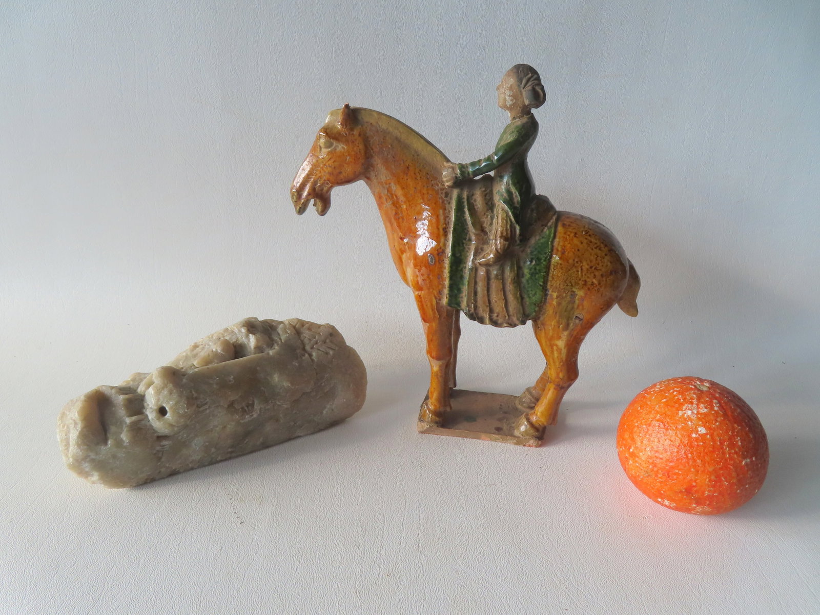 Two early sculptures. The first, an ancient Chinese earthenware tomb figure of lady on horseback, (1 of 9)