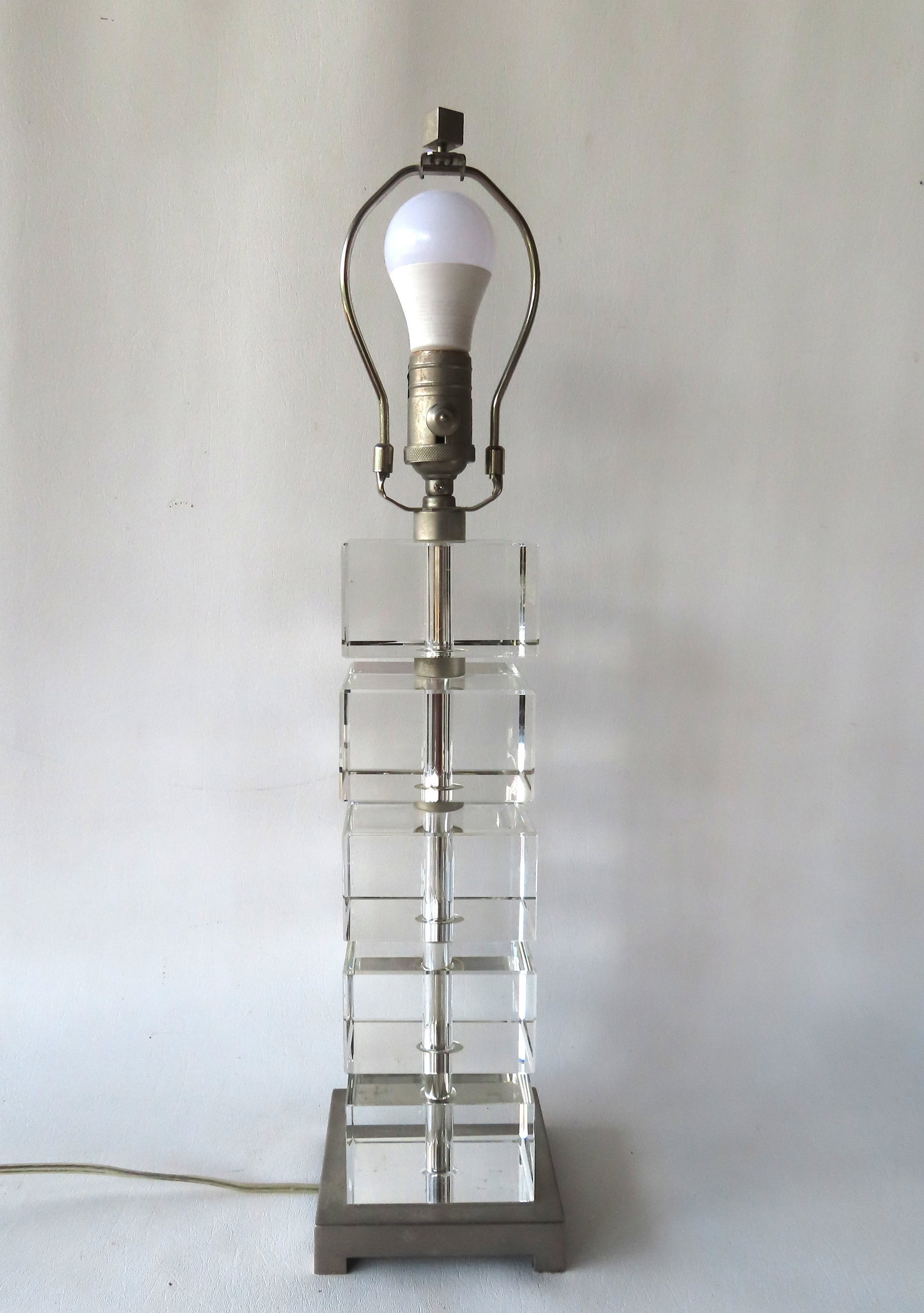 A mid-century style table lamp having five 4" square polished glass cubes with cut edges attached to: A mid-century style table lamp having five 4" square polished glass cubes with cut edges attached to central post that leads to a polished metal weighted cast iron base, circa 1970-80. Quality constru