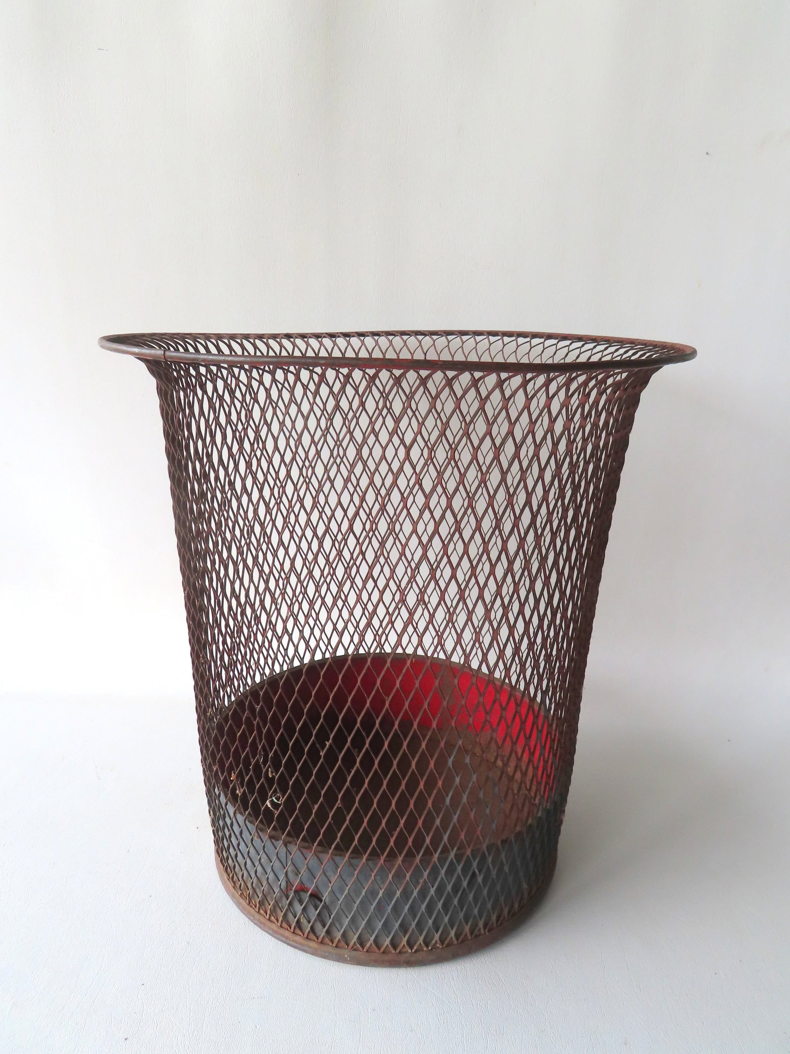 A vintage industrial wire office waste can with flared top, diamond mesh pattern, signed on base: A vintage industrial wire office waste can with flared top, diamond mesh pattern, signed on base "NEMCO" - patent date is worn but appears to read Jan. 30, '20. Good overall condition with traces of o