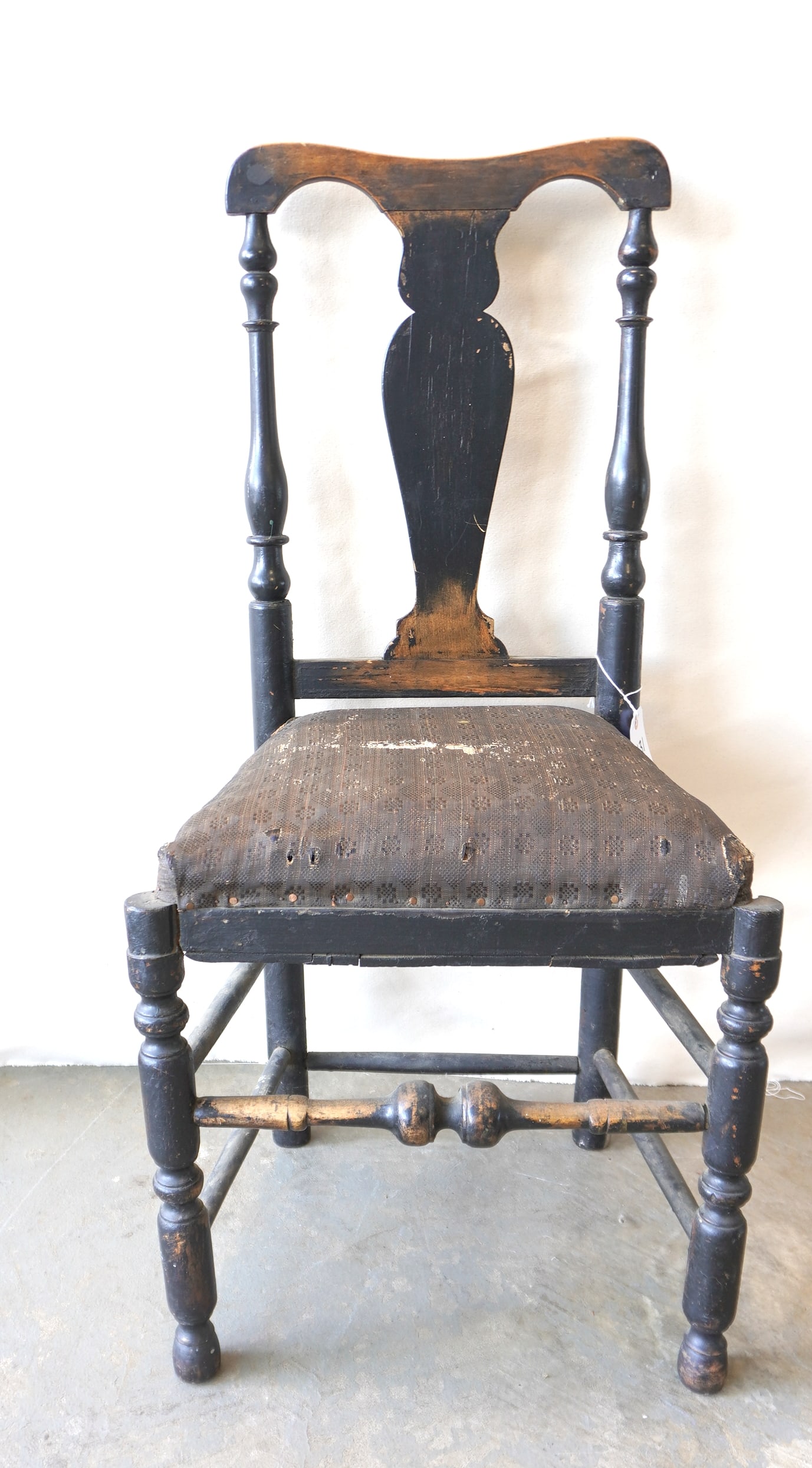 A good Queen Ann side chair, yolk crest, vasiform splat, turned legs leading to button feet and: A good Queen Ann side chair, yolk crest, vasiform splat, turned legs leading to button feet and having bulbous cross stretcher, old black paint which may be original, mid 18th century. The seat with h