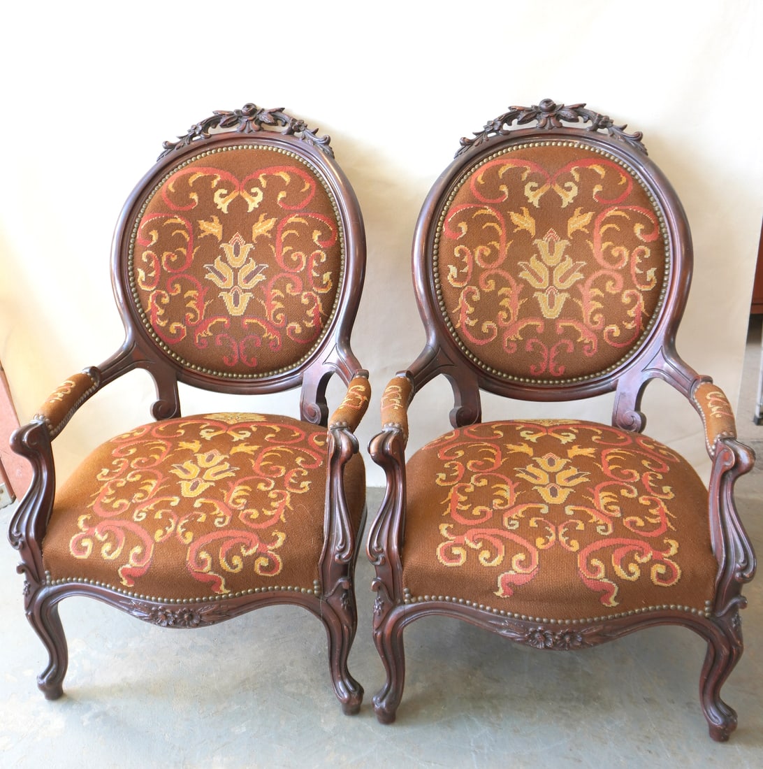 A pair of gents Victorian black walnut parlor chairs with needlepoint seats and back decorated with (1 of 7)