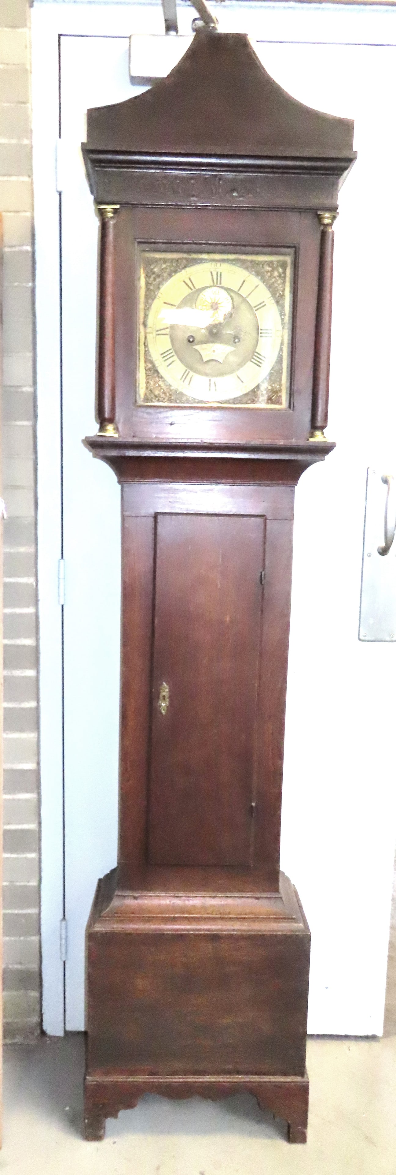 An 18th century English oak tall case clock with brass dial and works and having a cutout base. The (1 of 20)