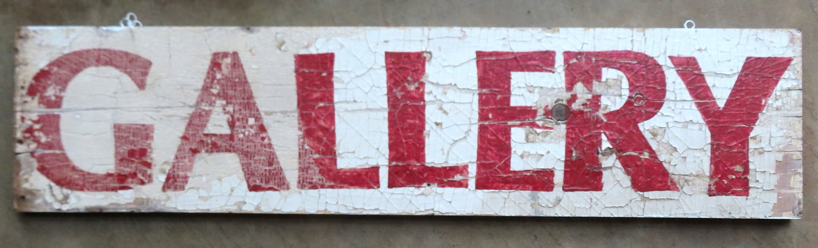 An old wooden sign marked "GALLERY" in original maroon lettering on white ground, possibly a (1 of 4)