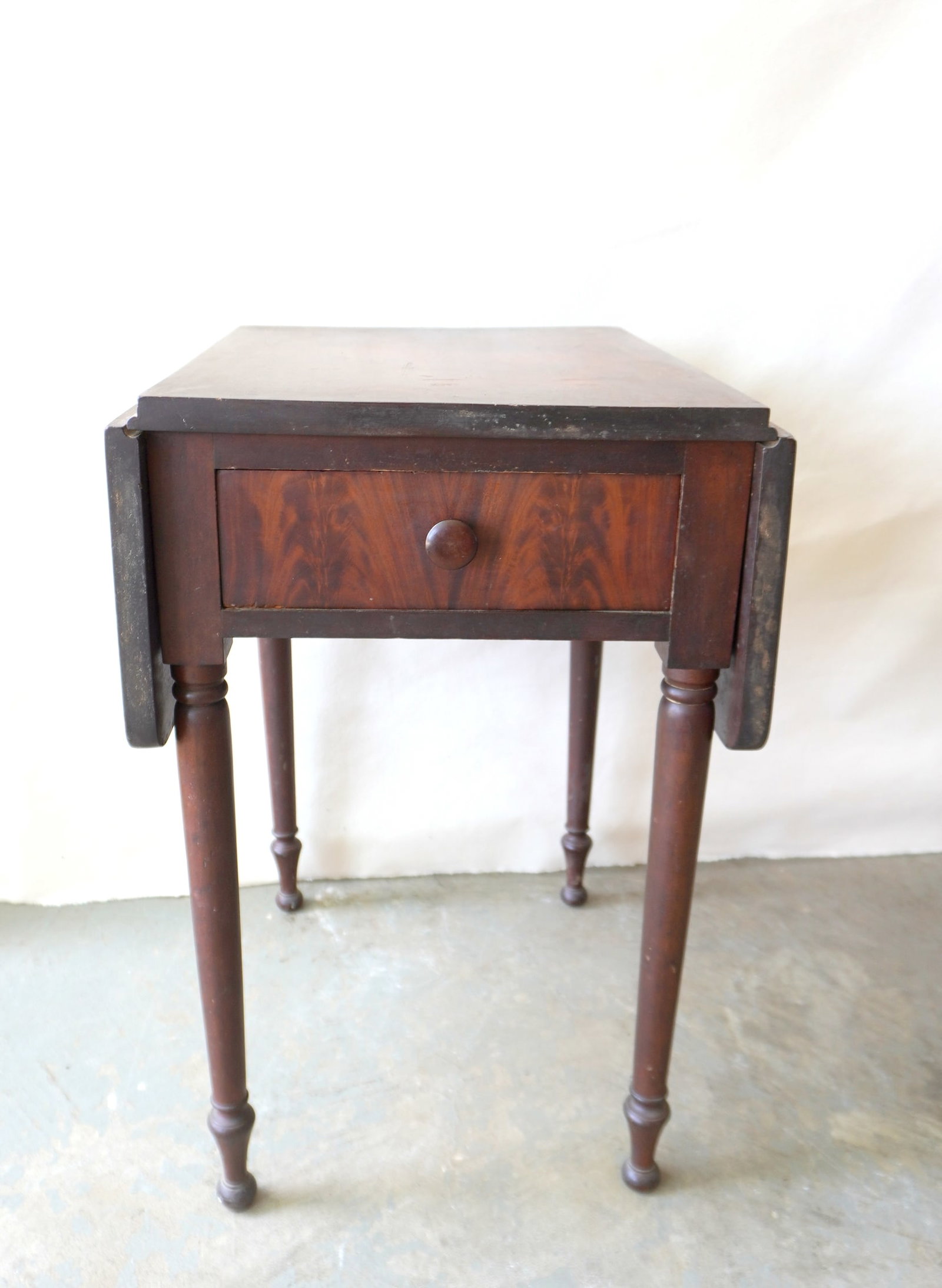 A Sheraton cherry drop-leaf sewing stand with flaming mahogany drawer. (1 of 7)