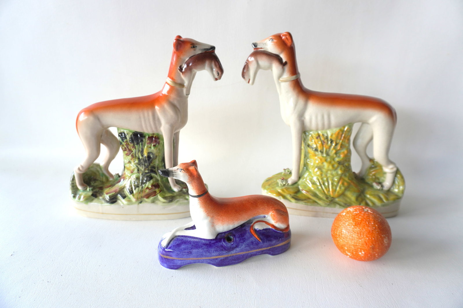 Three Staffordshire Greyhound dogs including a matched pair of 2 holding game in mouth; and a (1 of 7)