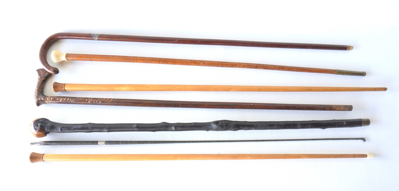 Grouping 6 walking sticks, and 1 riding crop. Walking sticks include one with bone handle and (1 of 5)