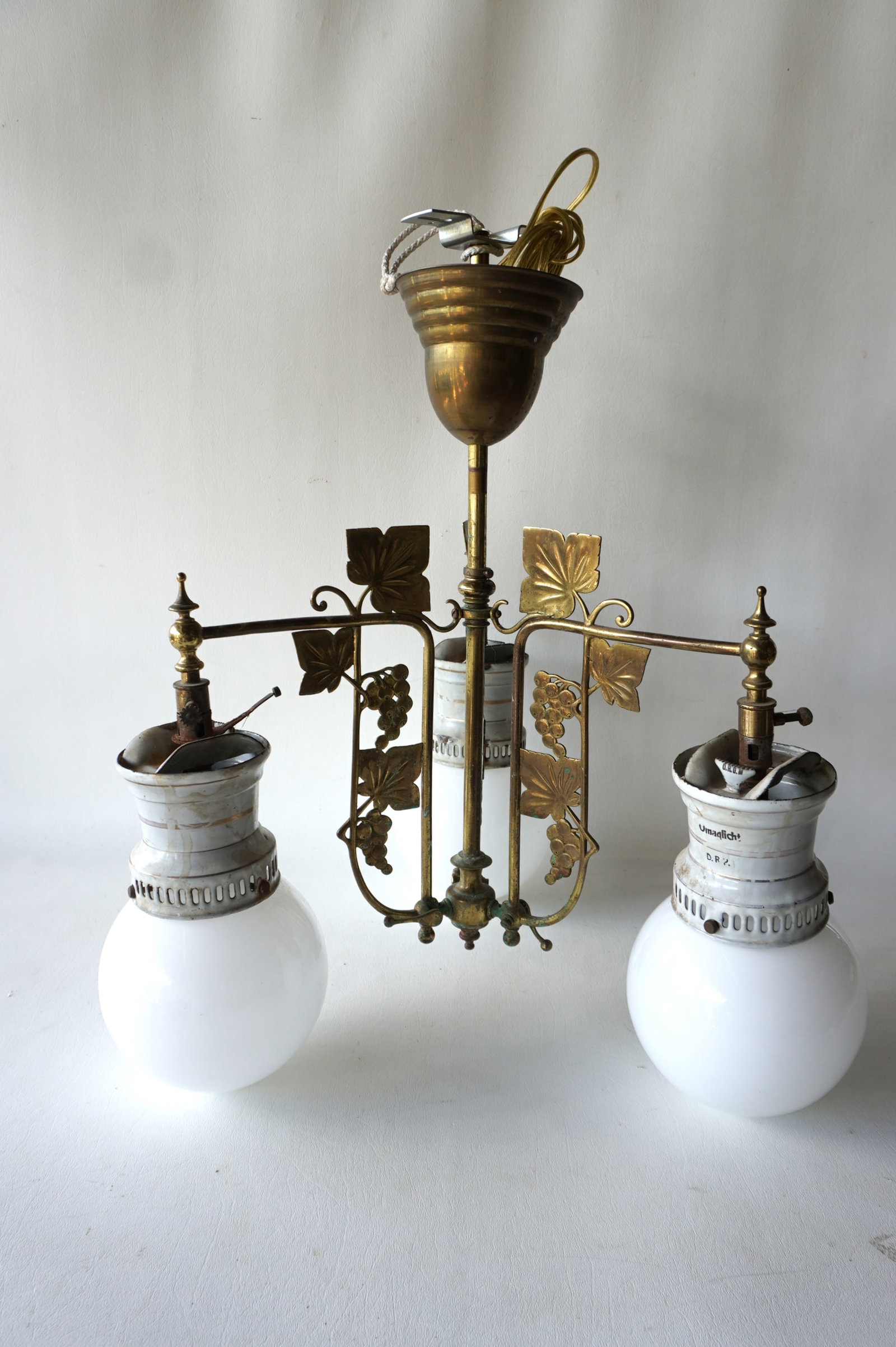 A Victorian era brass gas hall fixture with 3 arms holding white globes - the enameled tin fixture (1 of 5)