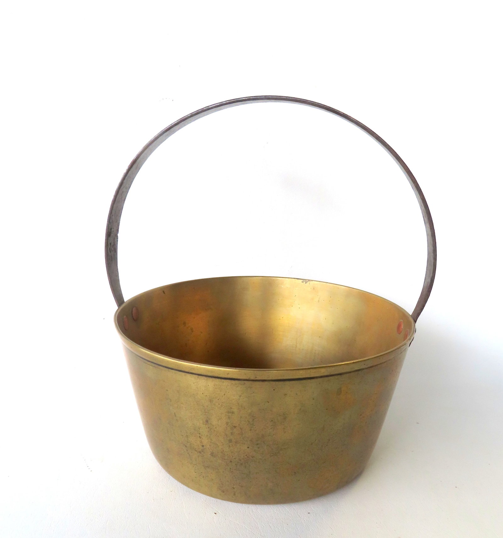 A very fine brass bucket with single hand forged iron loop handle attached to pot with brass rivets, (1 of 6)