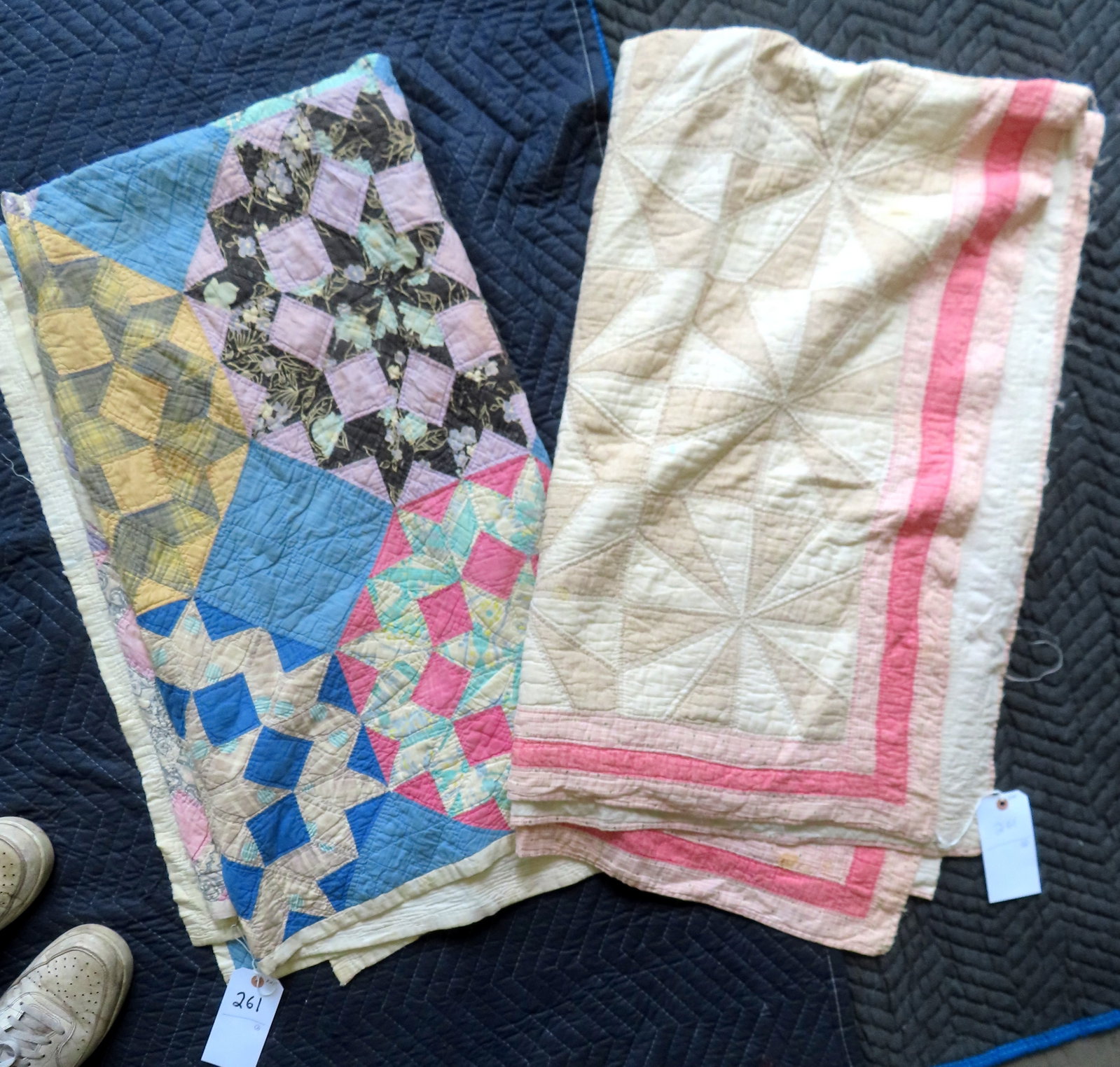 Two patchwork quilts, both hand sewn. The first in xx pattern. Circa 1920-30 - some brown stains,: Two patchwork quilts, both hand sewn. The first in xx pattern. Circa 1920-30 - some brown stains, and some patches with fraying, overall fair condition - measures 66" x 78"; the second in a pinwheel p
