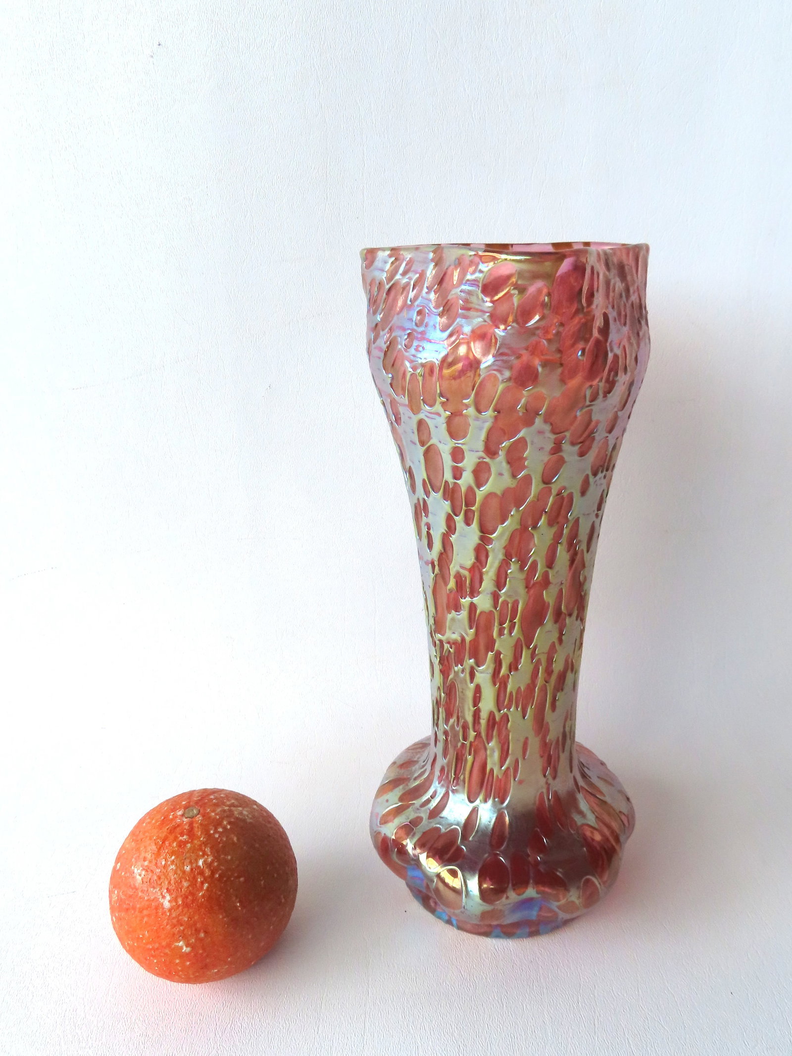 A Loetz iridescent pink Orbulin vase with pinched mouth and base and having a polished pontil. Not: A Loetz iridescent pink Orbulin vase with pinched mouth and base and having a polished pontil. Not marked, but clearly as described, circa 1900. Excellent condition with no damage or repairs. Measures