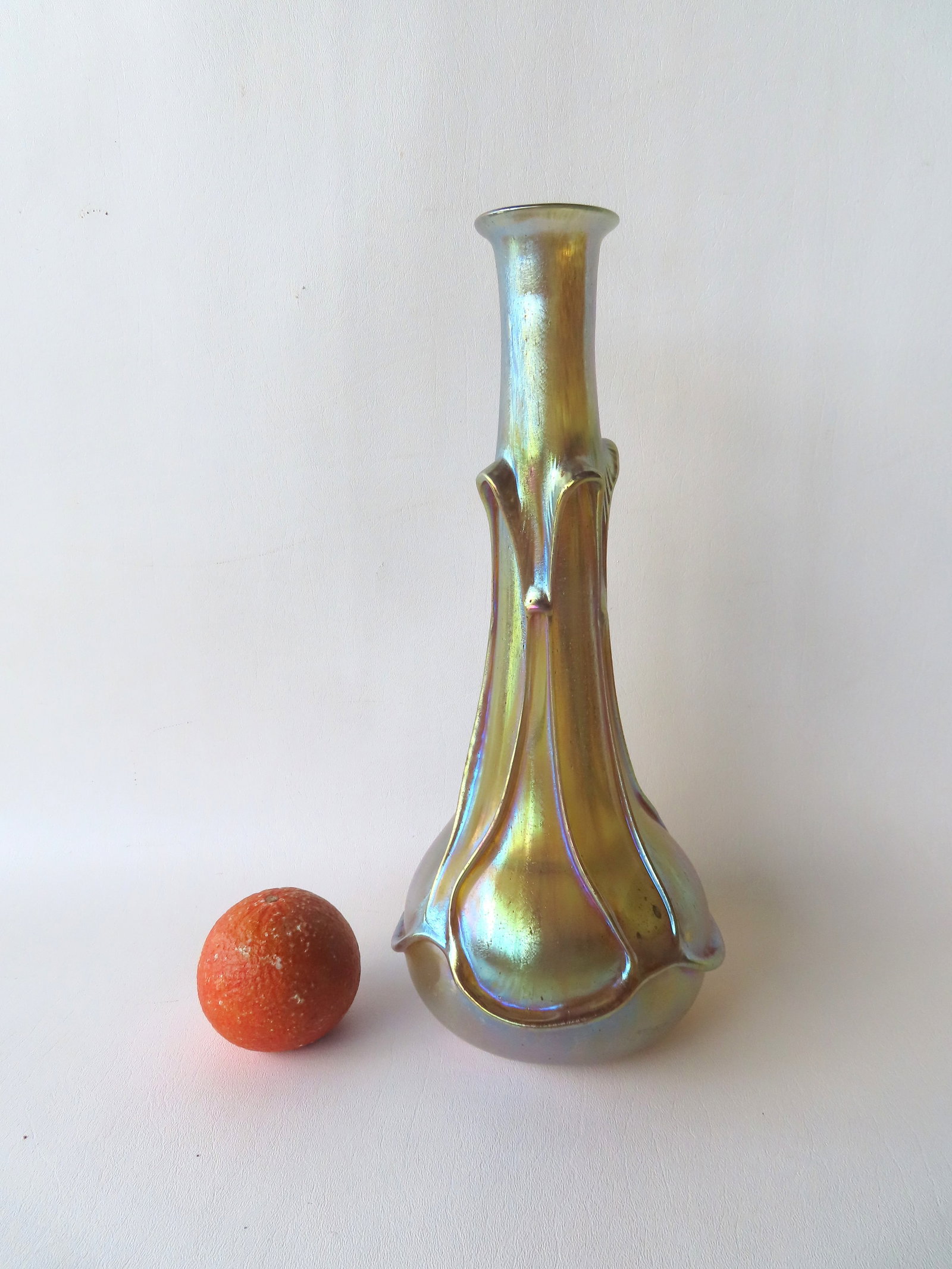 A Loetz gold iridescent vase, hand blown with polished pontil, signed "Loetz / Austria". Excellent: A Loetz gold iridescent vase, hand blown with polished pontil, signed "Loetz / Austria". Excellent condition, no damage. Measures 14 1/4"H x 6 1/4"W. Provenance: From the Marni Bakst and William