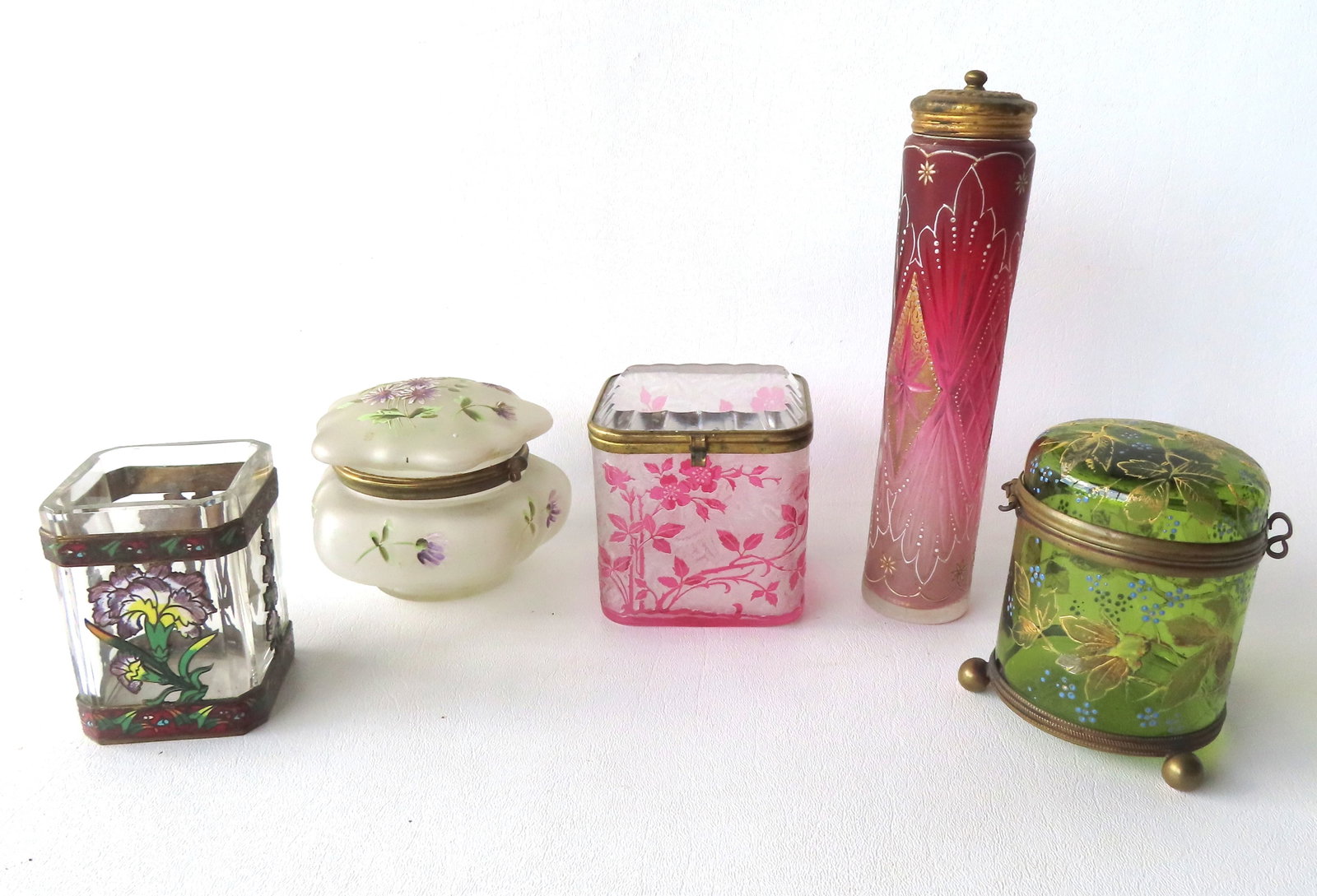 A grouping of 5 Victorian enameled dresser jars and bottle. Includes a translucent wavecrest dresser: A grouping of 5 Victorian enameled dresser jars and bottle. Includes a translucent wavecrest dresser jar decorated with flowers - very good condition, no damage; a square dresser jar (no lid) with