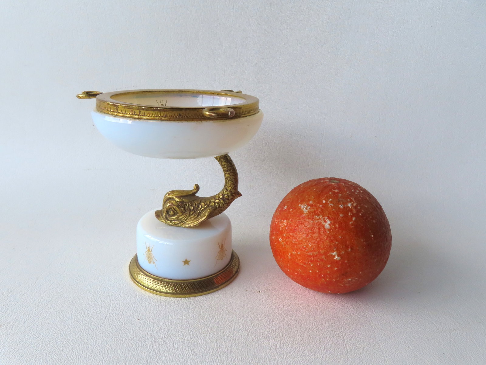 An unusual French white opalescent salt cellar or compote with bronze spoon holders attached to top: An unusual French white opalescent salt cellar or compote with bronze spoon holders attached to top brass or bronze edge - the bronze dolphin form pedestal is attached to a white opalescent circular