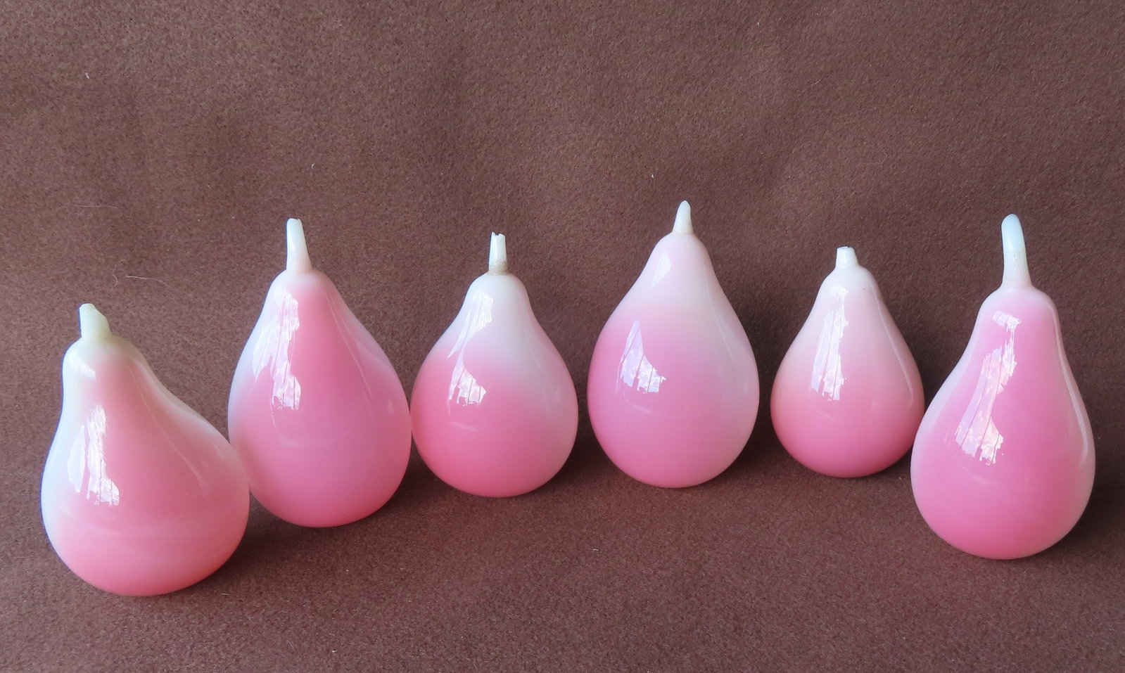 Grouping of 6 hand blown pink/white opalescent fruits in the shape of pears, all with polished: Grouping of 6 hand blown pink/white opalescent fruits in the shape of pears, all with polished pontils, 19th century in very good condition - note the stems of all in different sizes but appear to