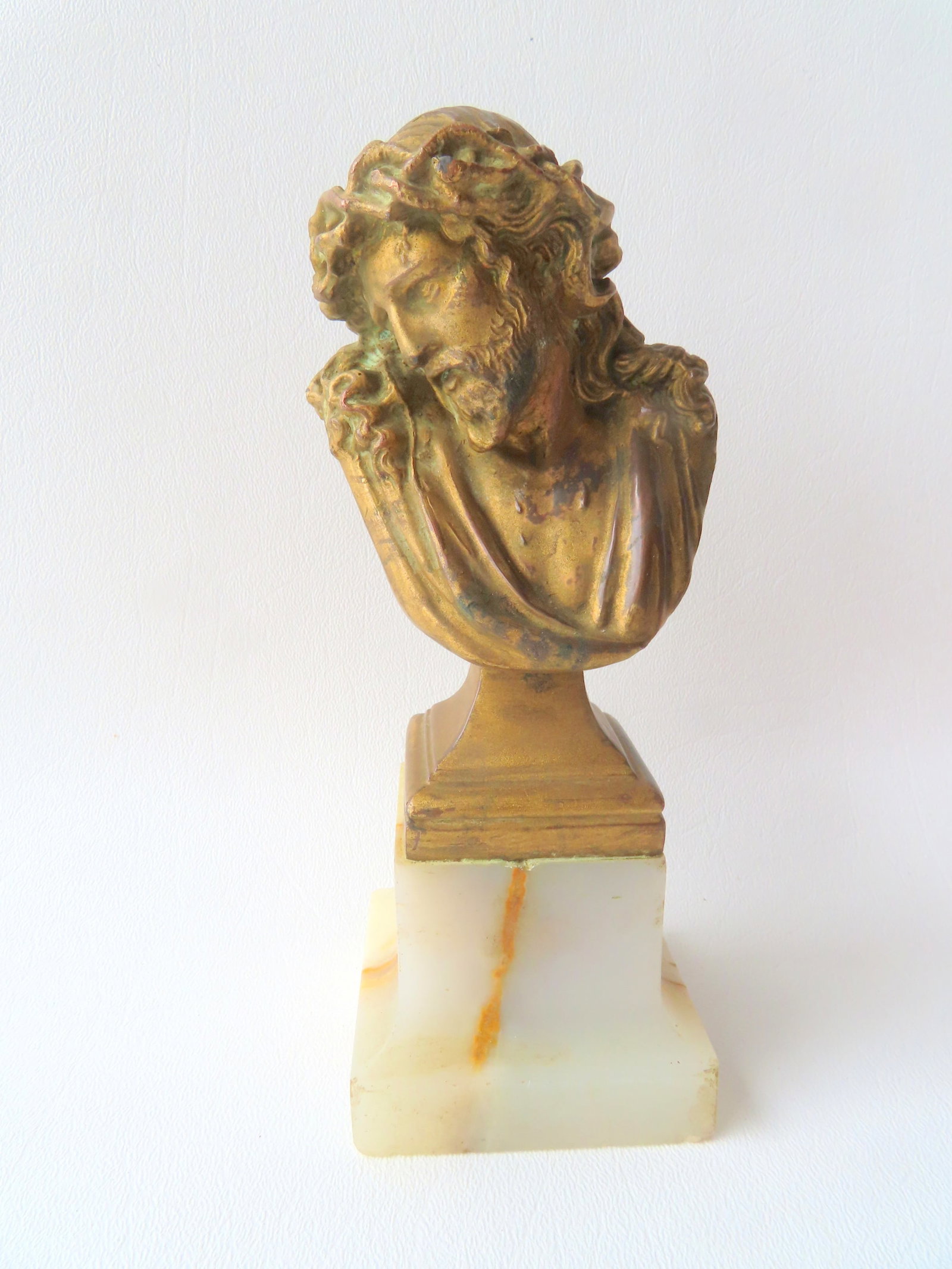 A small gilt bronze sculpture of Jesus mounted on a marble plinth, signed illegibly, 19th century.: A small gilt bronze sculpture of Jesus mounted on a marble plinth, signed illegibly, 19th century. Very good condition. 6 1/4"H x 2 3/8" square at base. Provenance: From a Rochester NY estate.