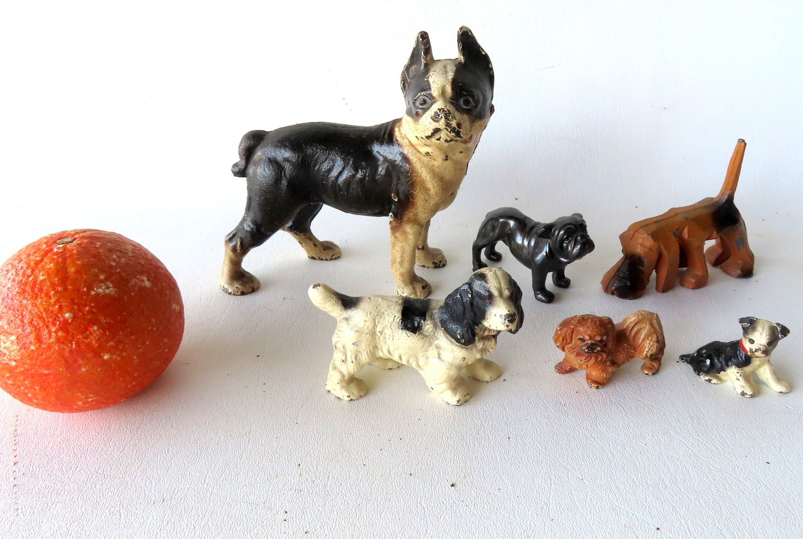 A Hubley cast iron Boston Bull bank in original paint in very good condition, measures 5 1/2"L x 5: A Hubley cast iron Boston Bull bank in original paint in very good condition, measures 5 1/2"L x 5 3/8"H, circa 1900; together with 5 miniature metal dog figurines, all in good condition, mid to late 