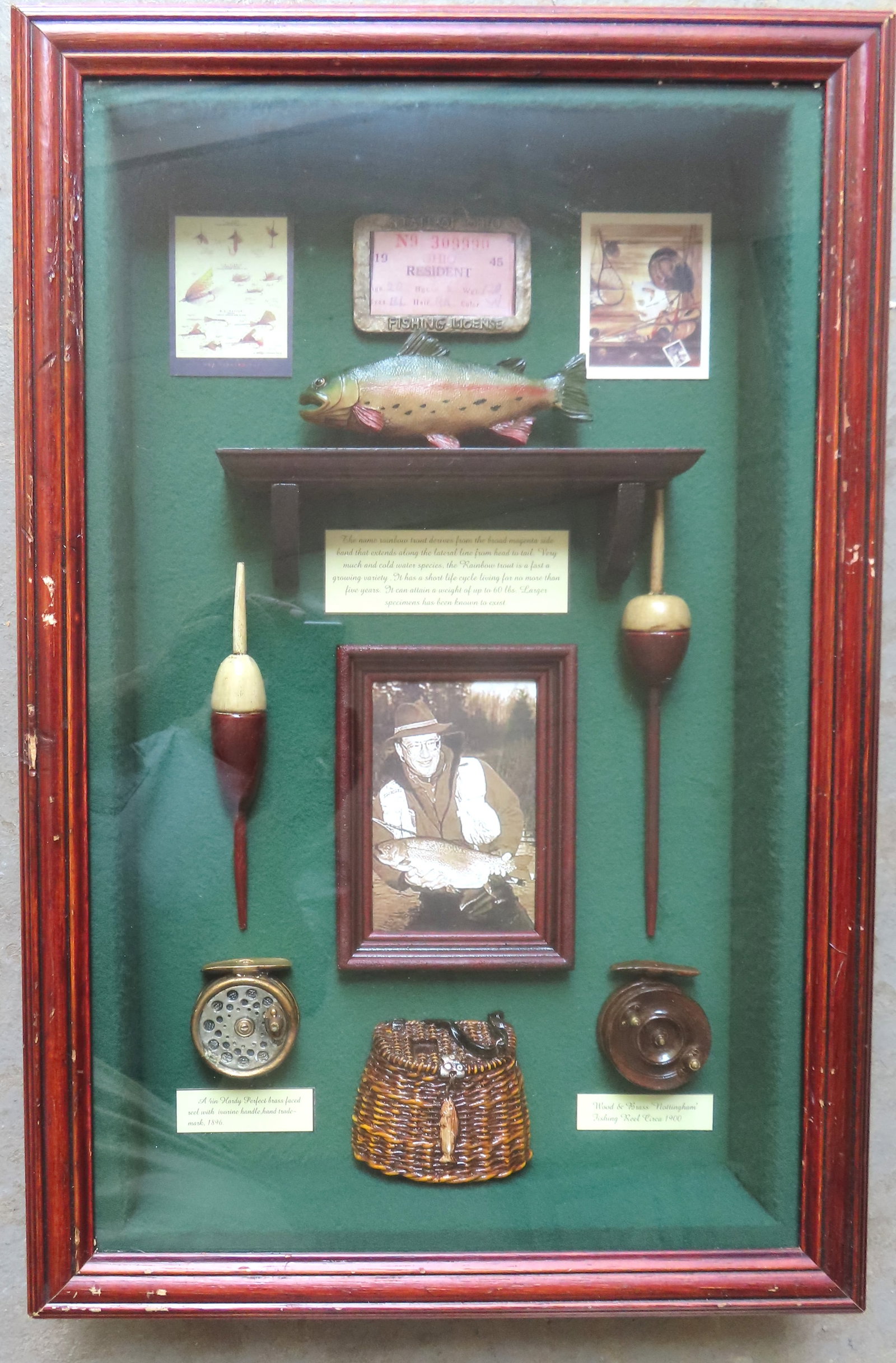 A fishing diorama, memorial to a sportsman as defined in his fishing license. The reels appear to be (1 of 7)