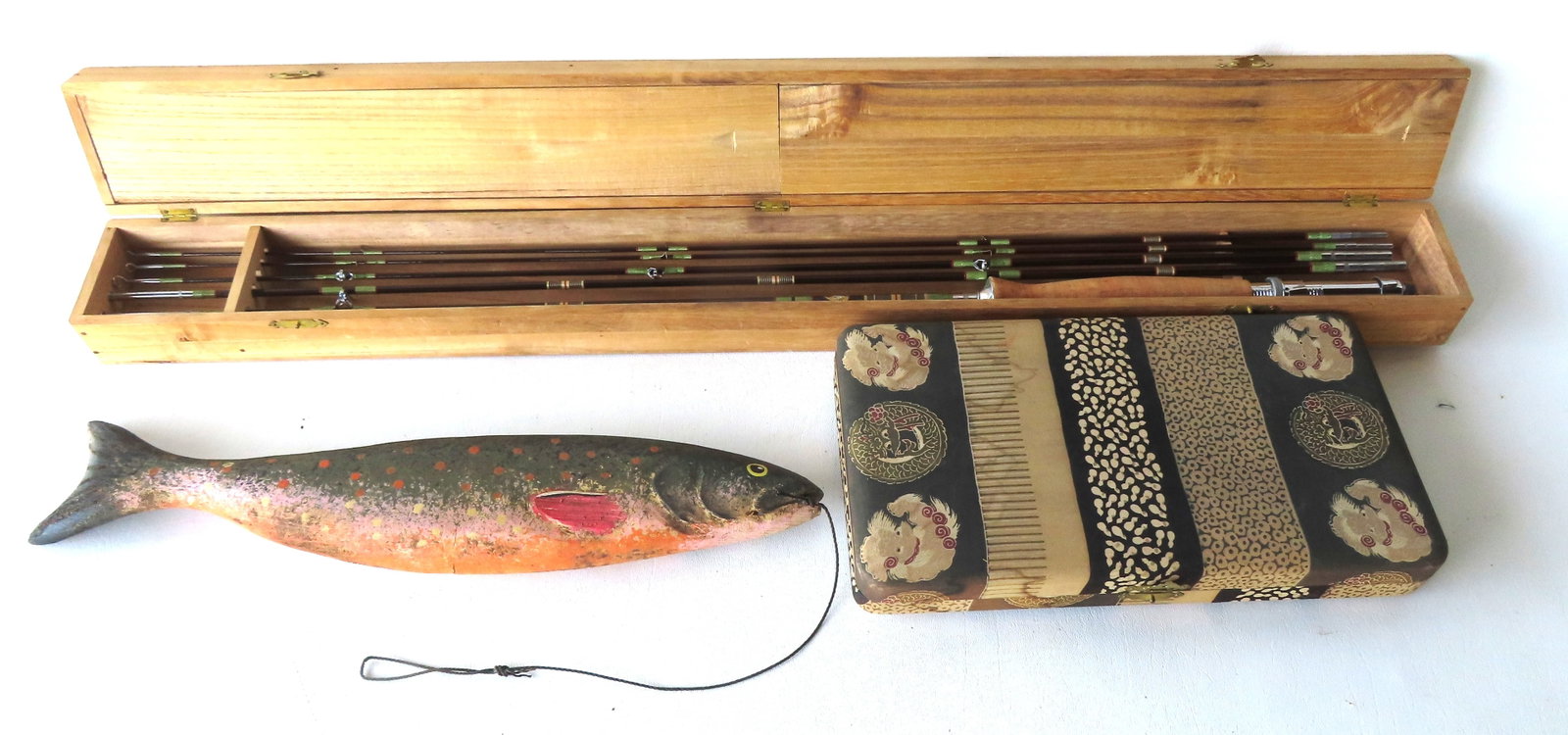Grouping of fishing collectibles: The first a carved wooden hand painted fish signed Randy Hofman -: Grouping of fishing collectibles: The first a carved wooden hand painted fish signed Randy Hofman - very good condition - 17 3/4"L; the second, a Japanese split bamboo fly rod in original wooden case,