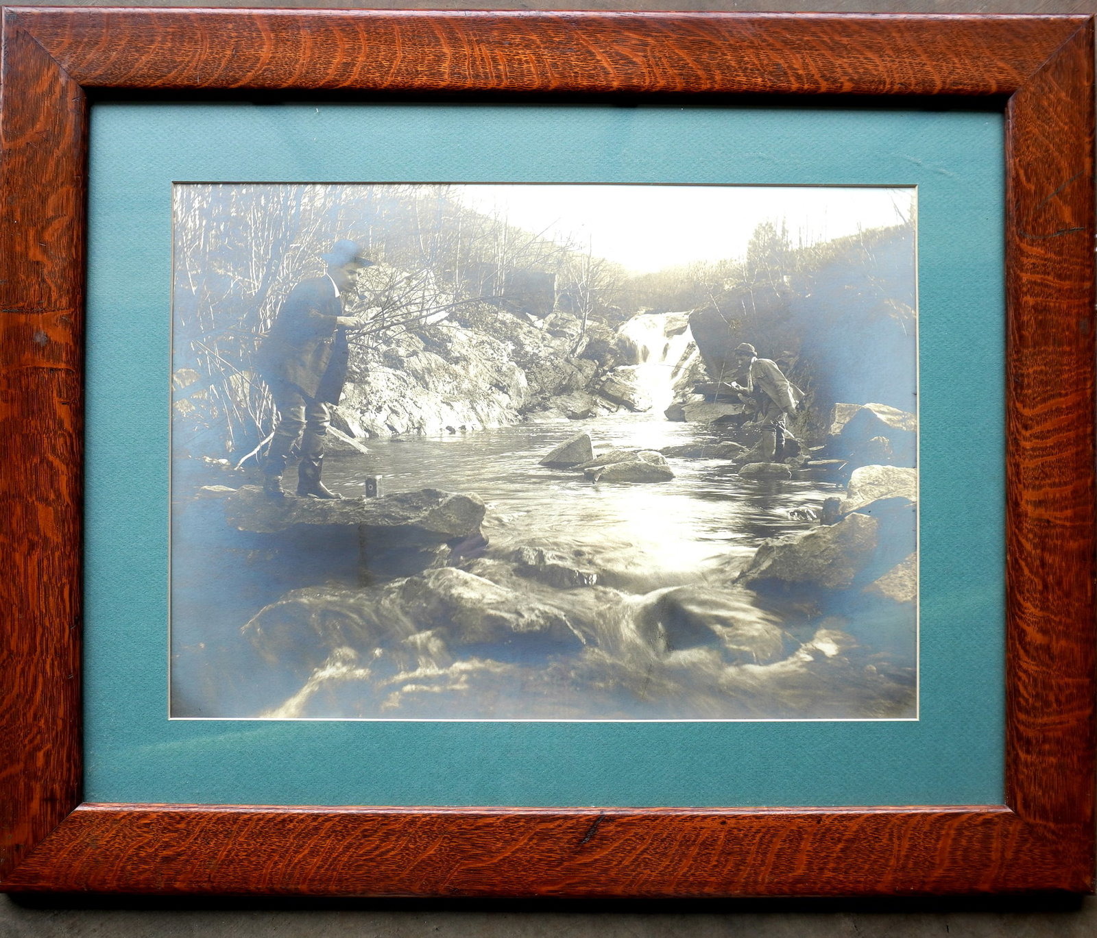 A rare large photo of 2 men fishing in local area stream, one with hooked trout. Hand written: A rare large photo of 2 men fishing in local area stream, one with hooked trout. Hand written inscription of reverse marked "John Smith, Oct. 27, 1915 / Poughkeepsie N.Y." and housed in it's original 
