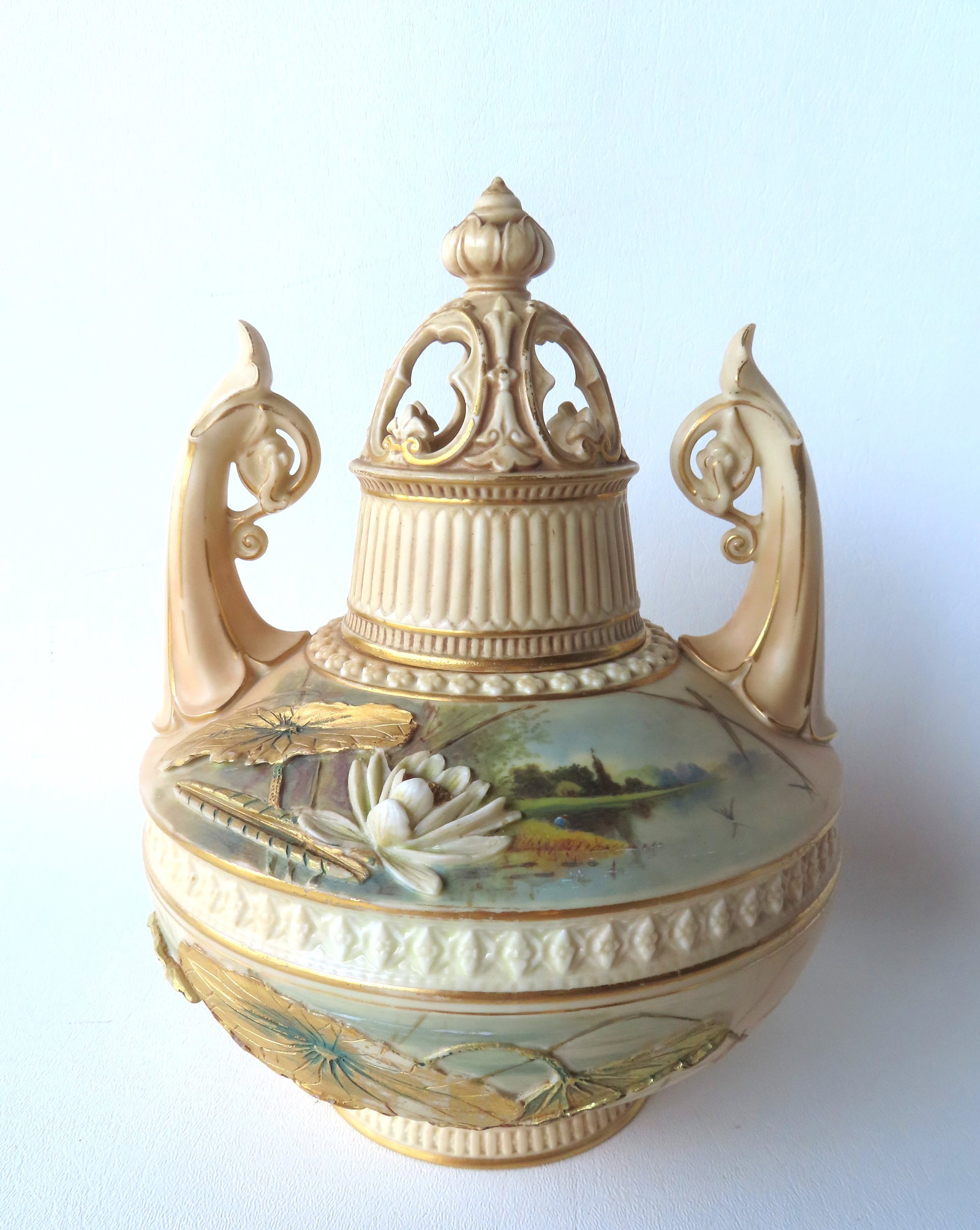 The best Royal Worcester jar with double lids, scrolled handles having hand painted lily pads along: The best Royal Worcester jar with double lids, scrolled handles having hand painted lily pads along the lower half of body and raised porcelain hand painted lily pad and flower adjacent to a very fine