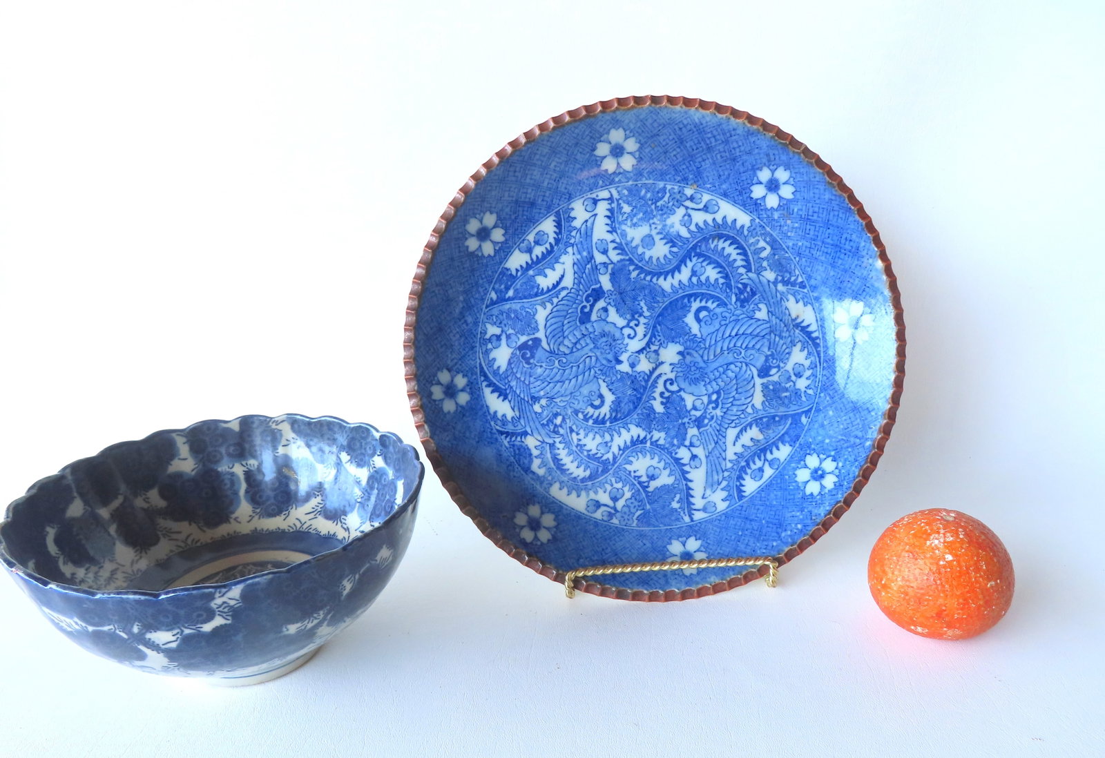 Two Chinese export blue and white porcelain charger and bowl. The first, a charger decorated with 2: Two Chinese export blue and white porcelain charger and bowl. The first, a charger decorated with 2 long winged stylized birds, one appearing to be an American Eagle, both surrounded by leaves and flo