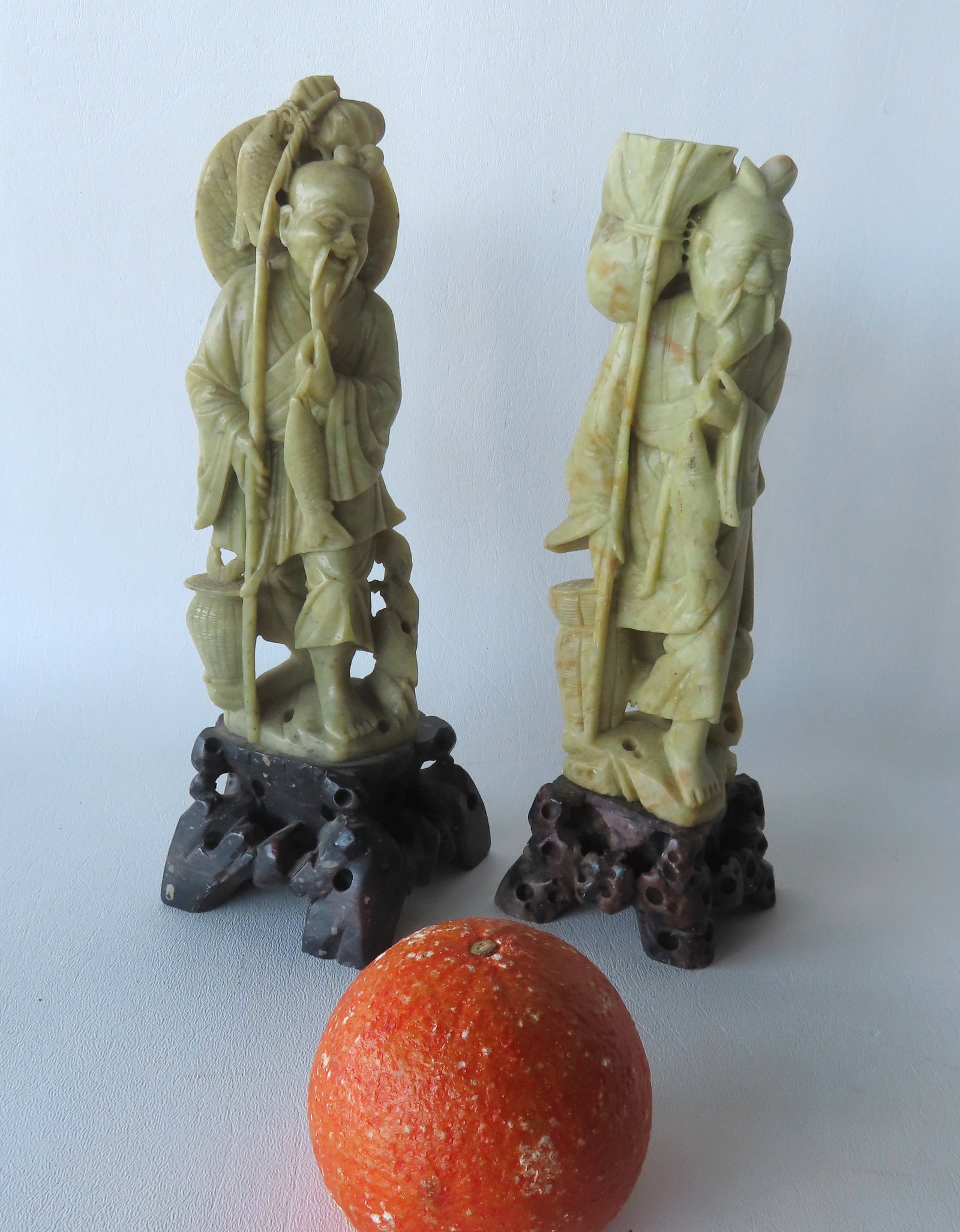 Two soapstone sculptures of oriental fishermen, both appear to be in very good condition. The: Two soapstone sculptures of oriental fishermen, both appear to be in very good condition. The largest measures 10 1/4"H. Provenance: From the Marni Bakst and William Sadler collection of antiques, Ver